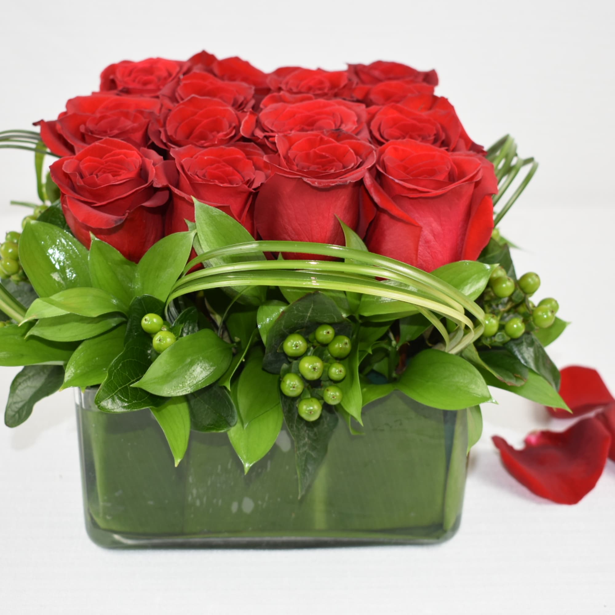 An amazing low arrangement with 16 Ecuadorian roses perfectly combined with some