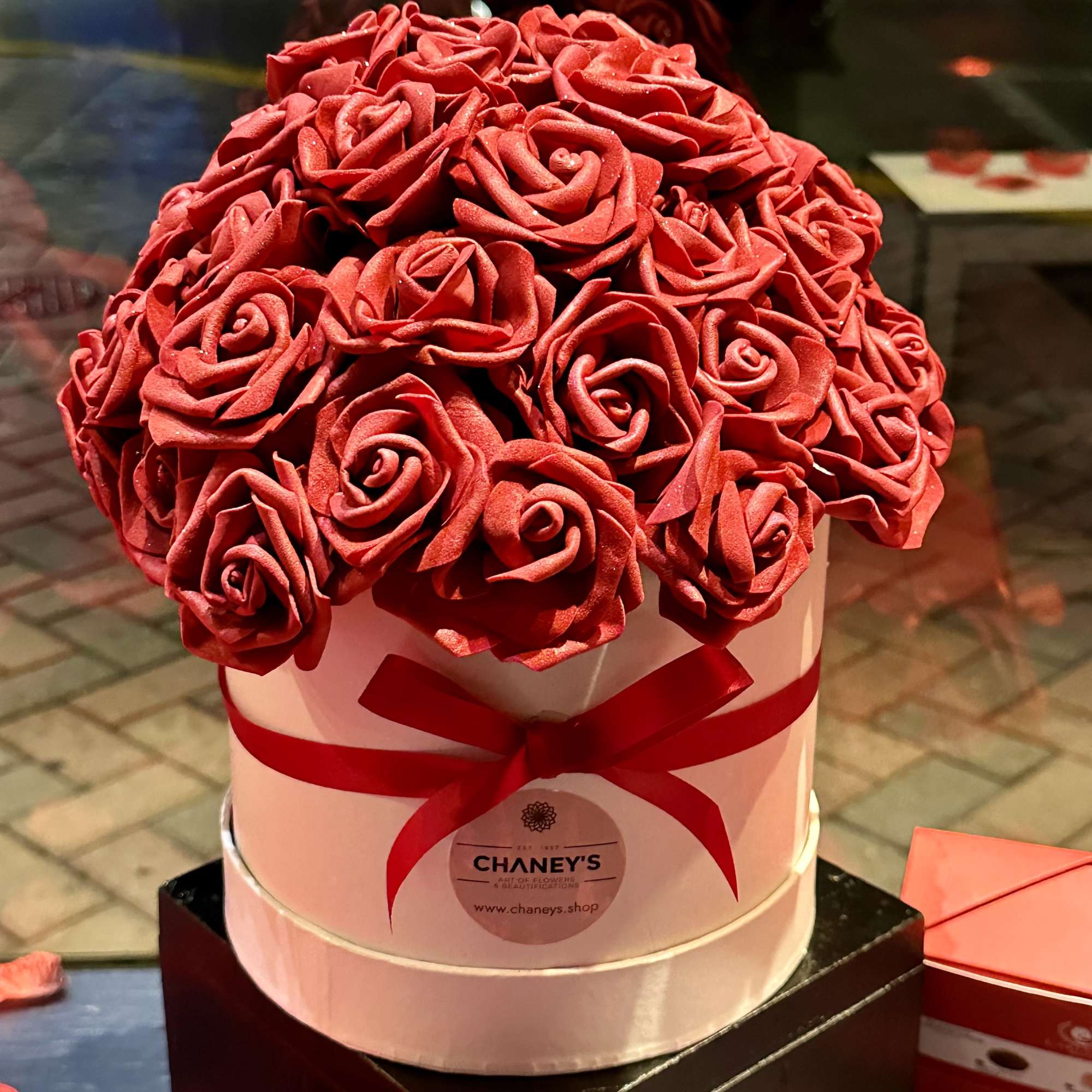 Fall in love with this beautiful designed box of artificial red roses.