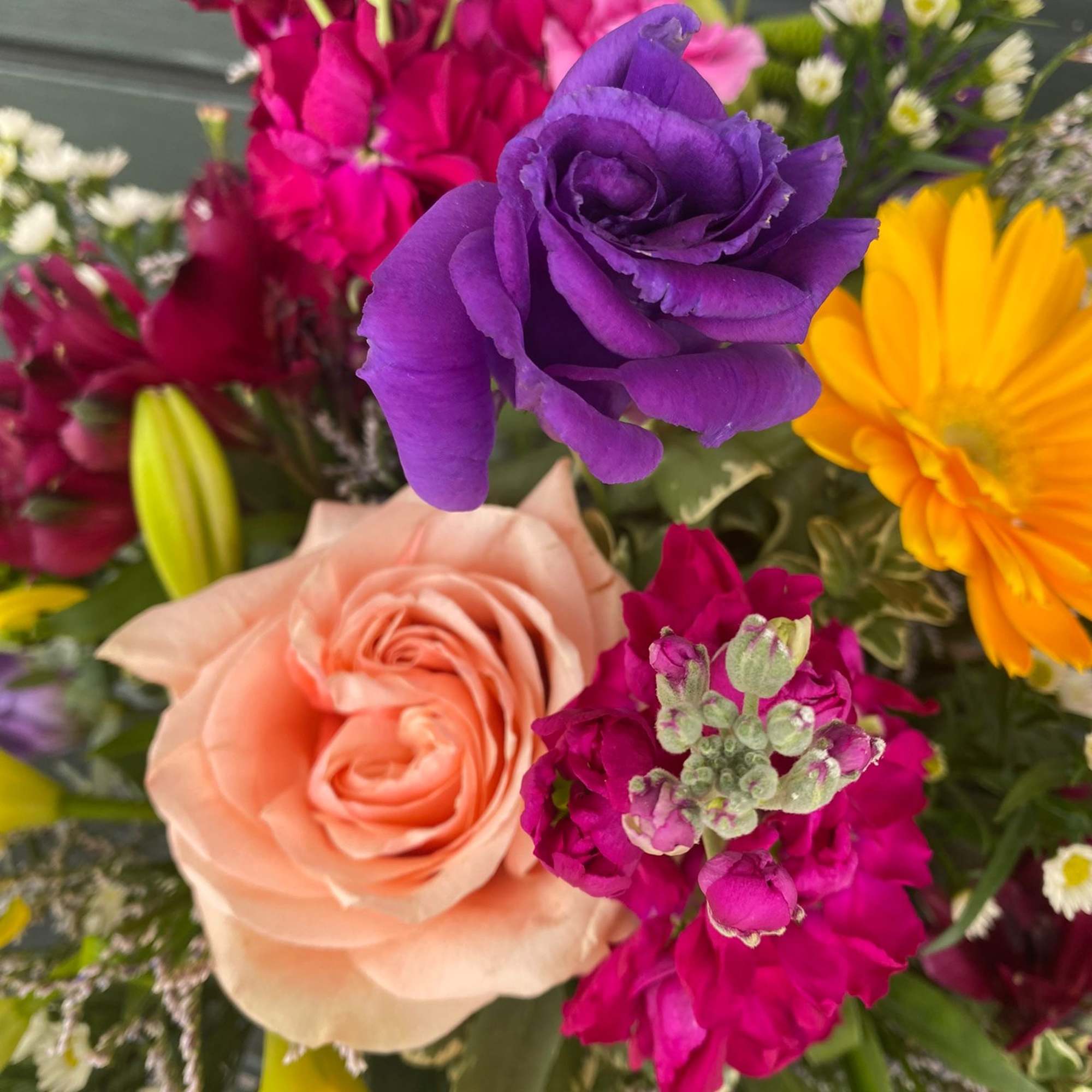 Bright and colorful flower bouquet including vase