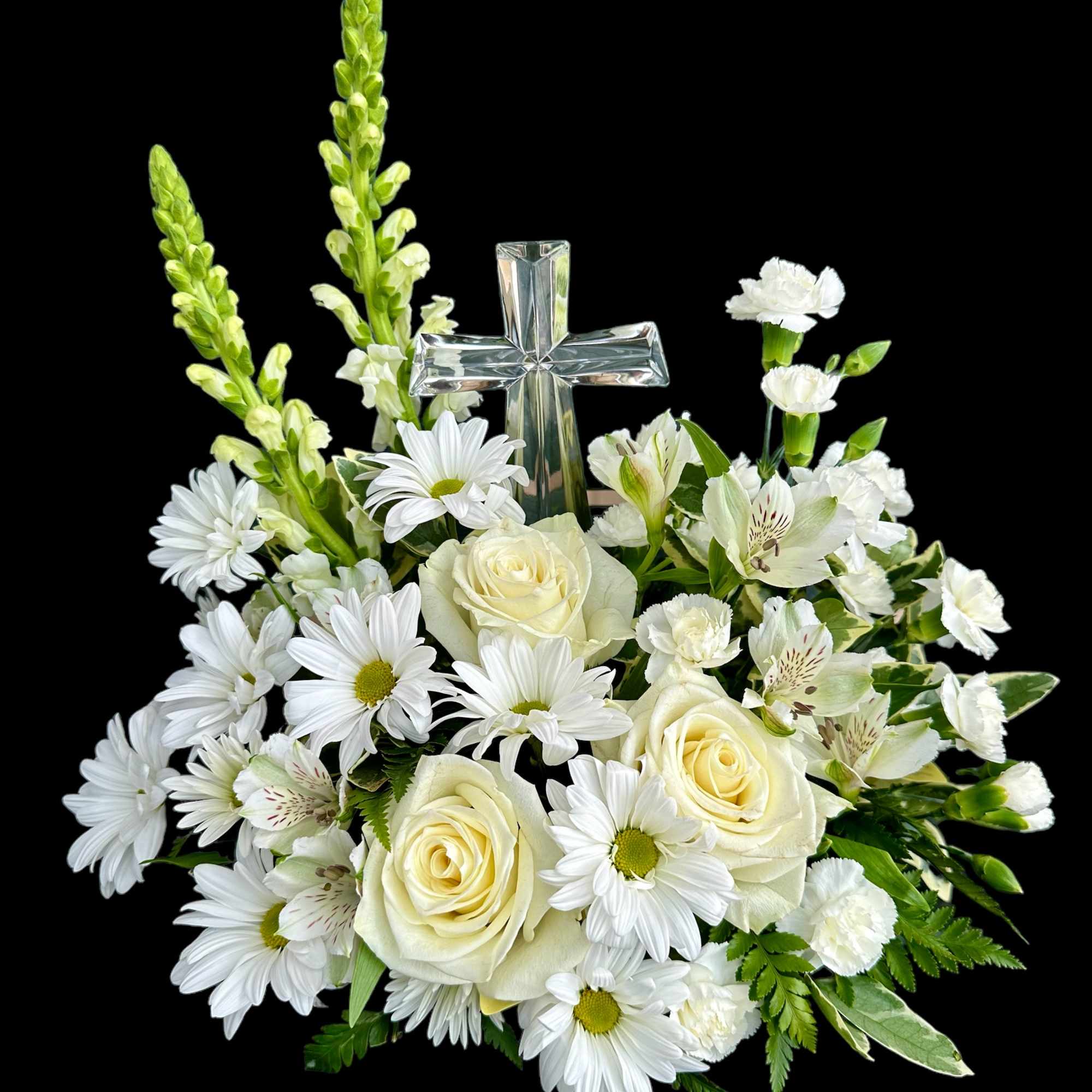 Sympathy arrangement with acrylic cross. Held in light colors.