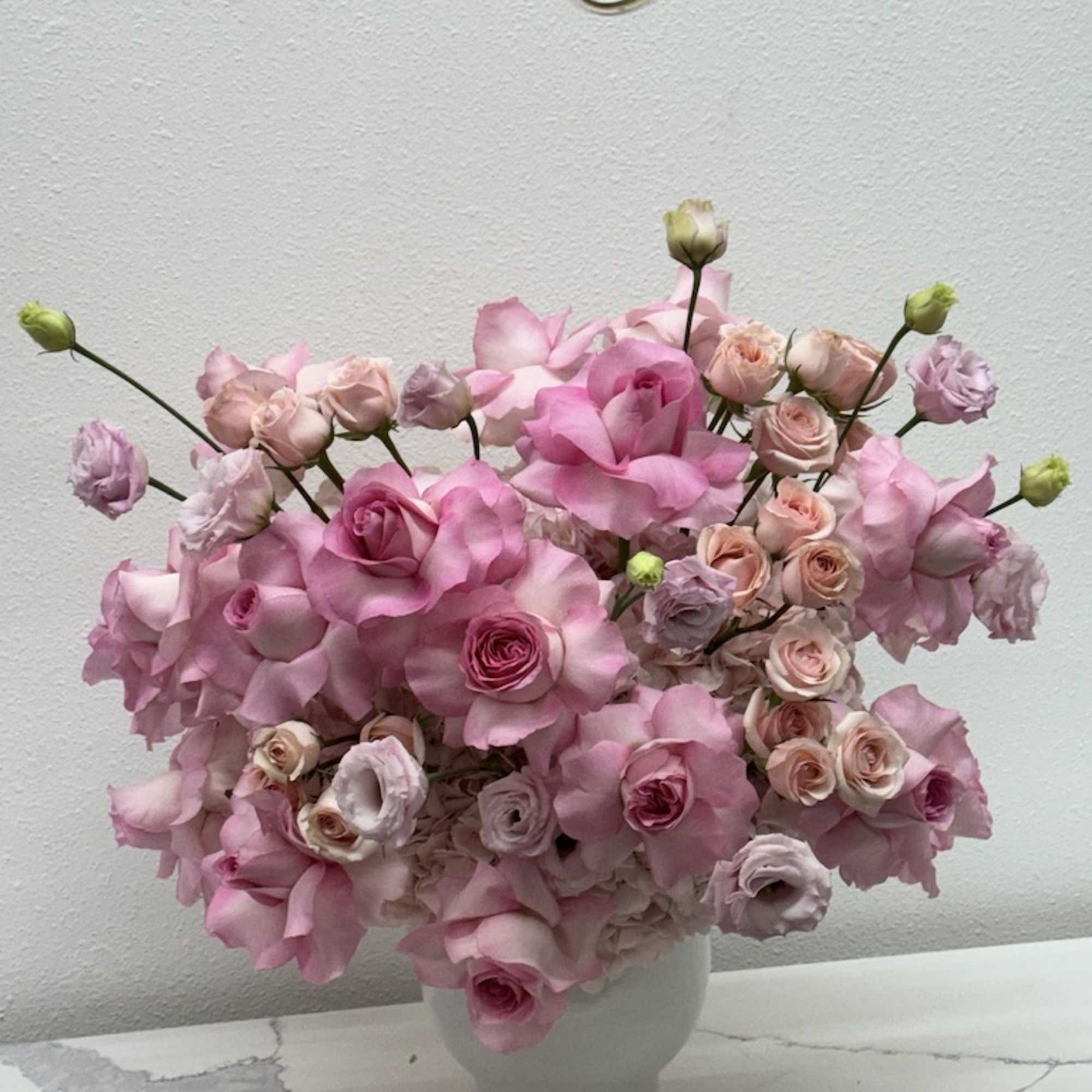 The modern style arrangement in the white vase is an exquisite display