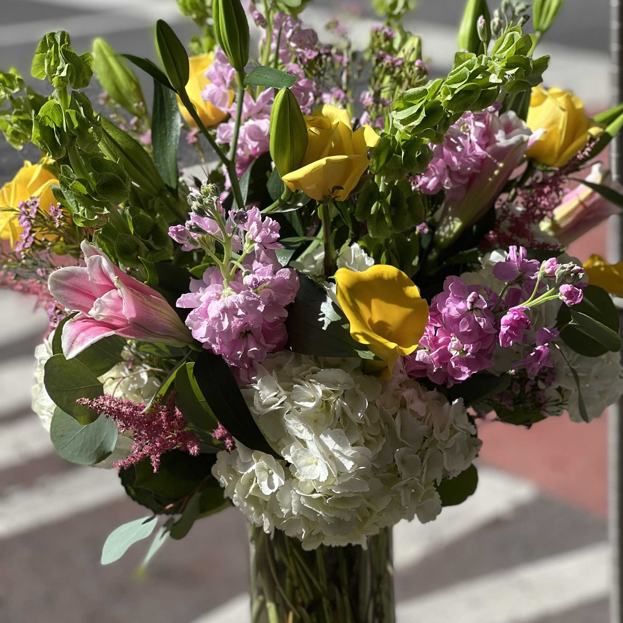 This lovey arrangement of bright, colorful and balanced flowers are ready to