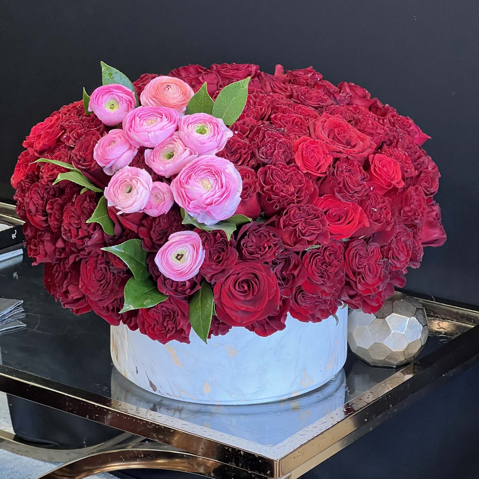 This stunning arrangement consists of only Red Roses &amp; Black Bacara Red