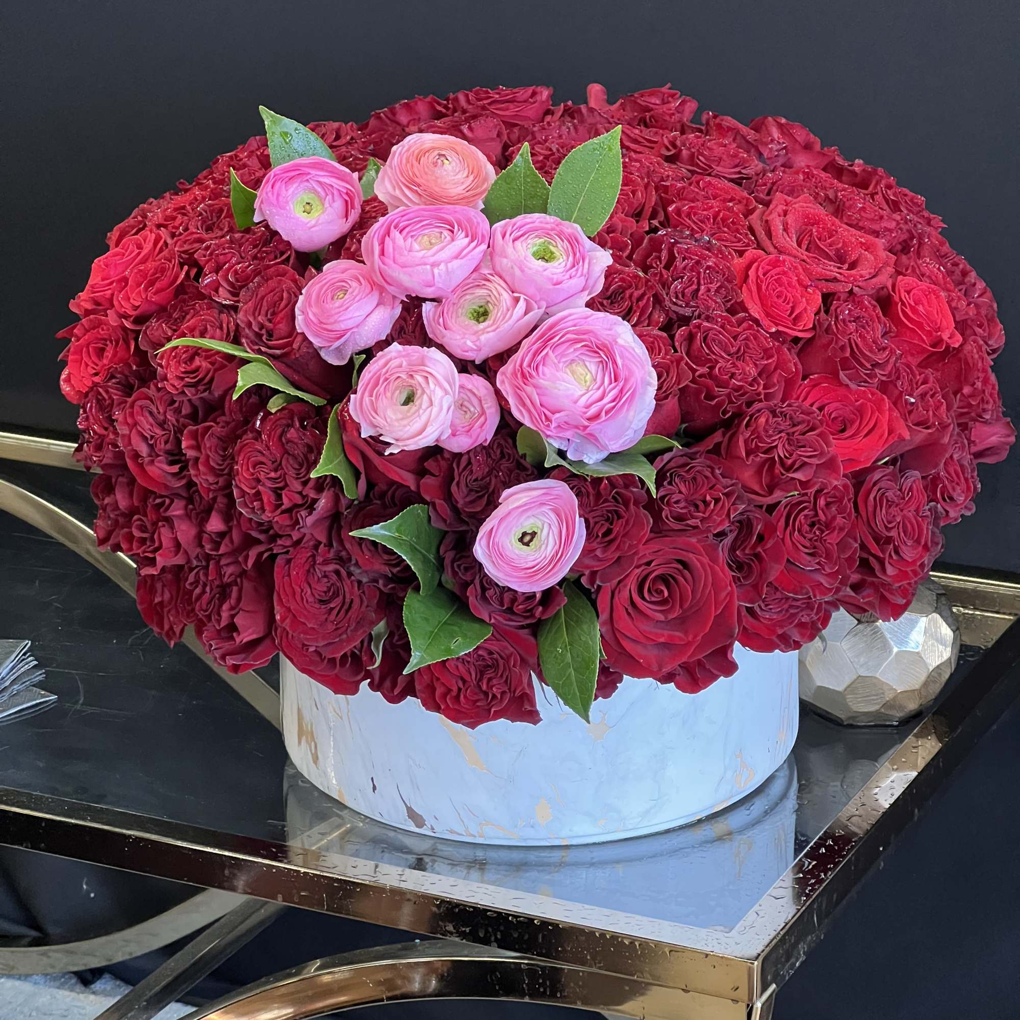 This stunning arrangement consists of only Red Roses &amp; Black Bacara Red