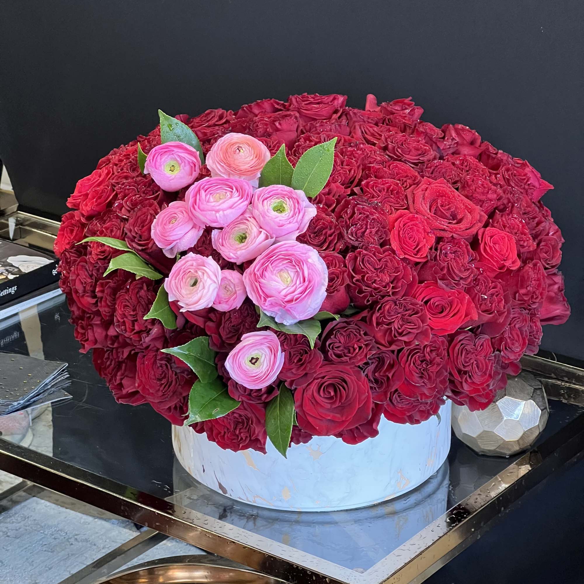This stunning arrangement consists of only Red Roses &amp; Black Bacara Red