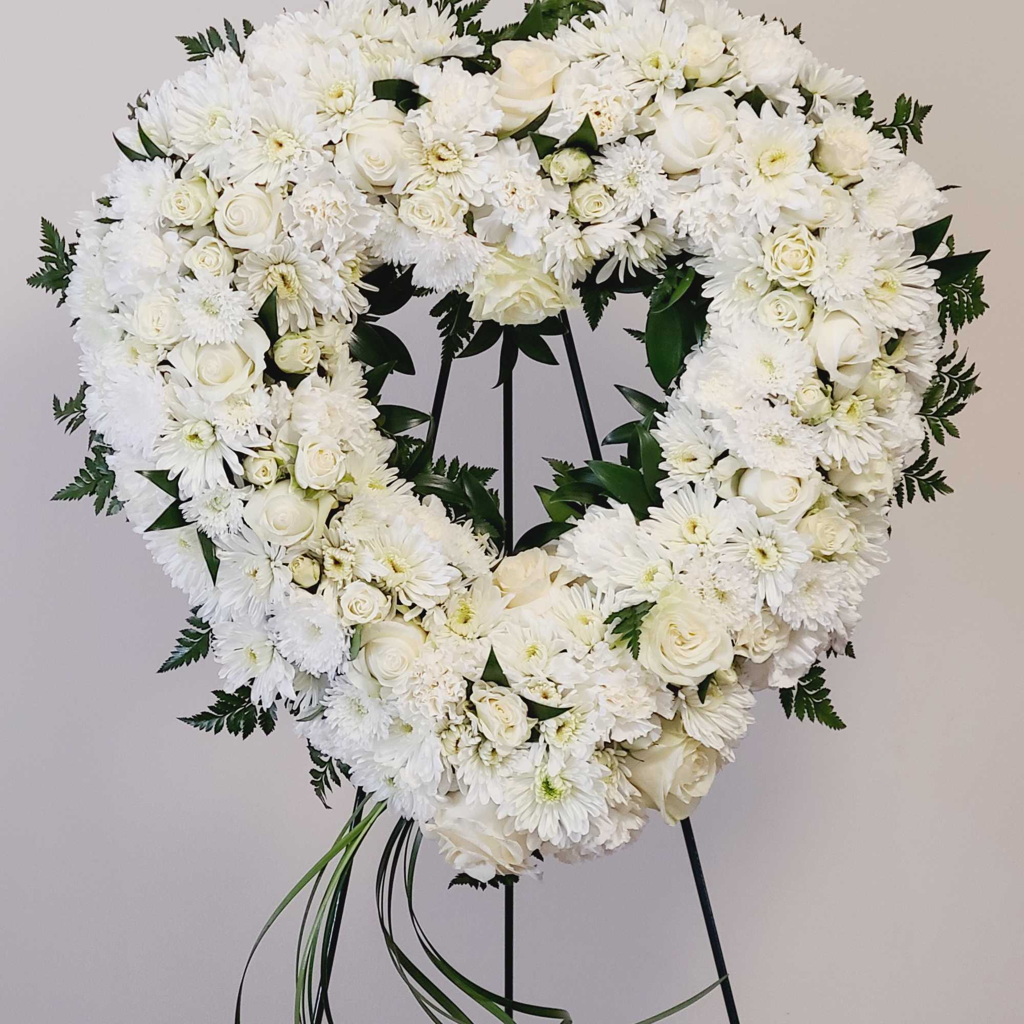 An all white tribute, this heart shaped easel shows your everlasting love. An all white tribute, this heart shaped easel shows your everlasting love.