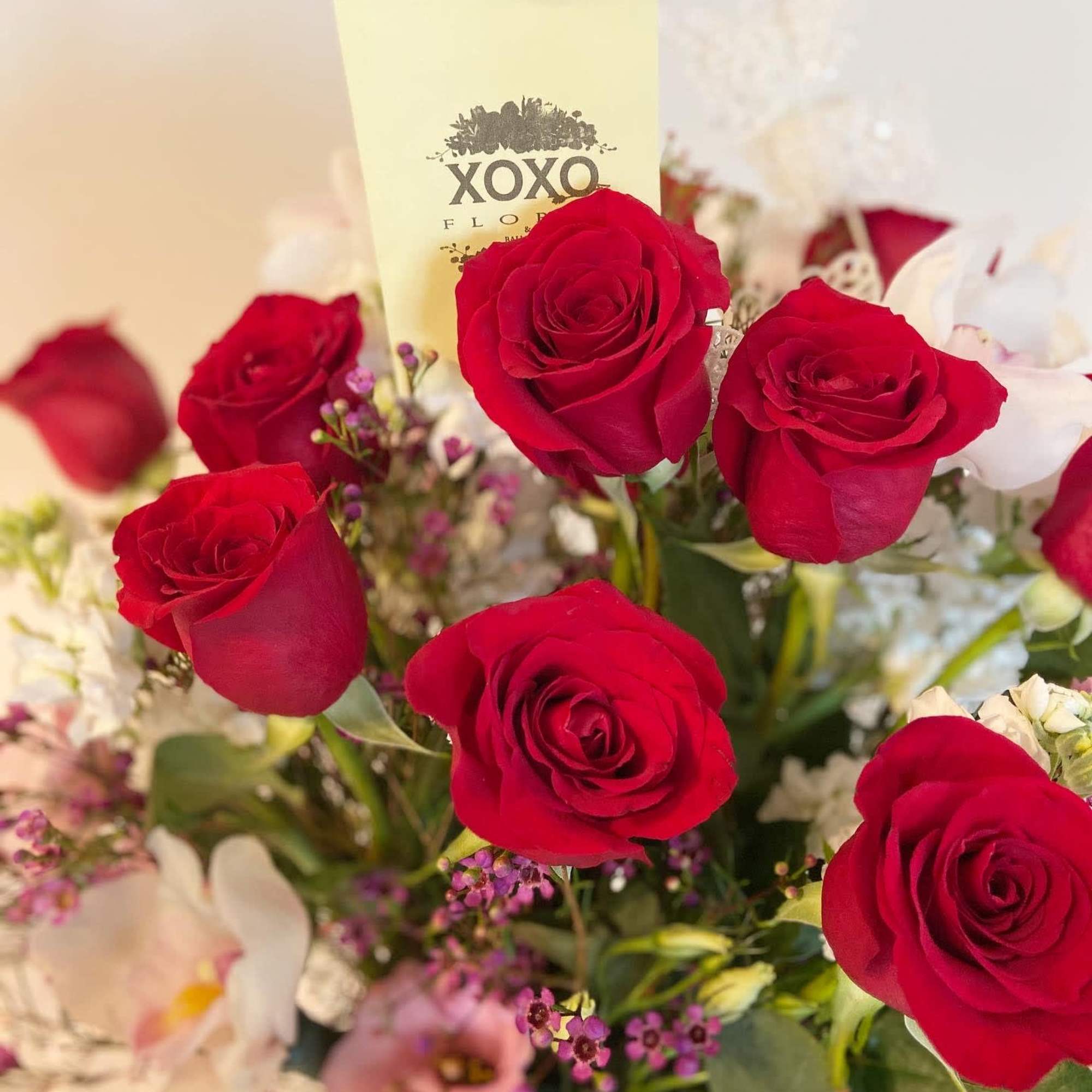 Truly Love
This arrangement includes white cymbidium orchids, 18 red roses, &amp; pink