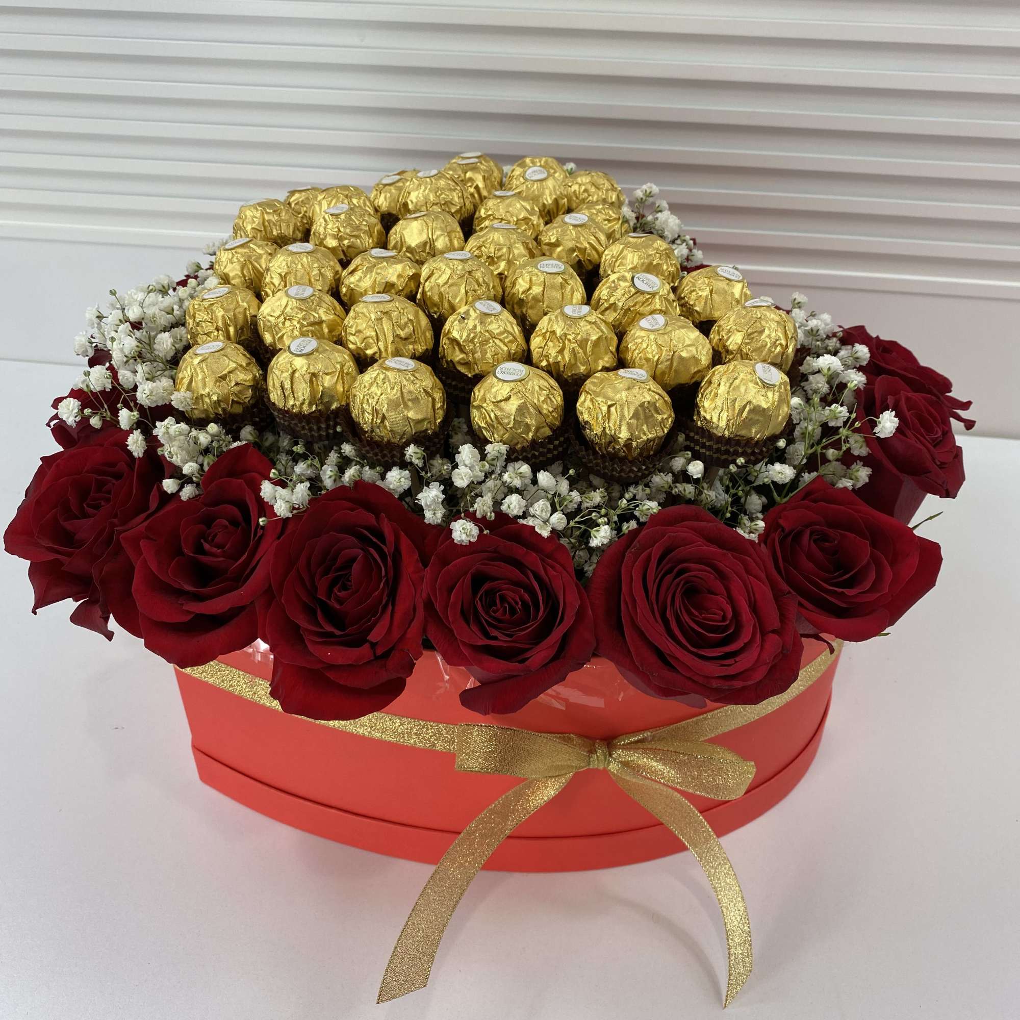 Red heart shape box filled with 20 roses and 32 Ferrero Rocher