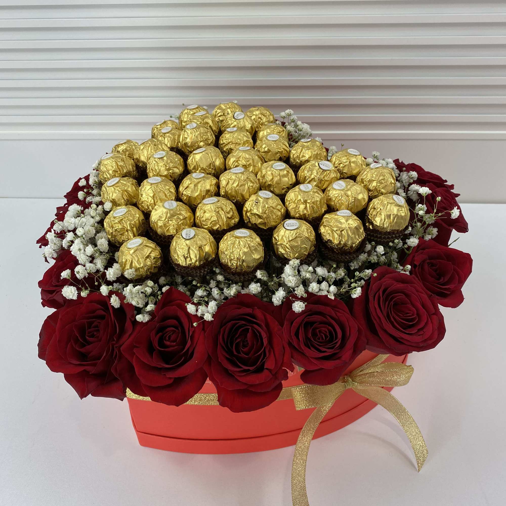 Red heart shape box filled with 20 roses and 32 Ferrero Rocher