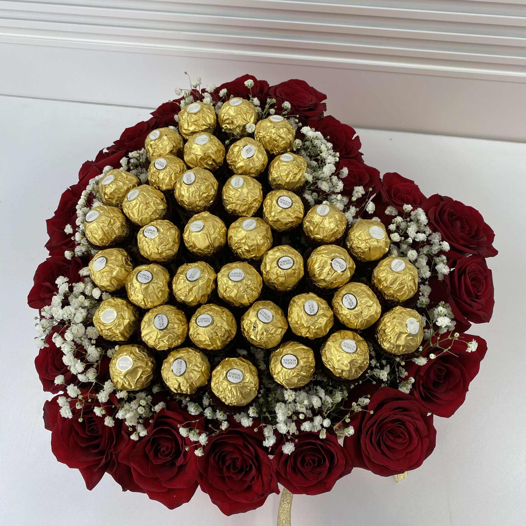 Red heart shape box filled with 20 roses and 32 Ferrero Rocher