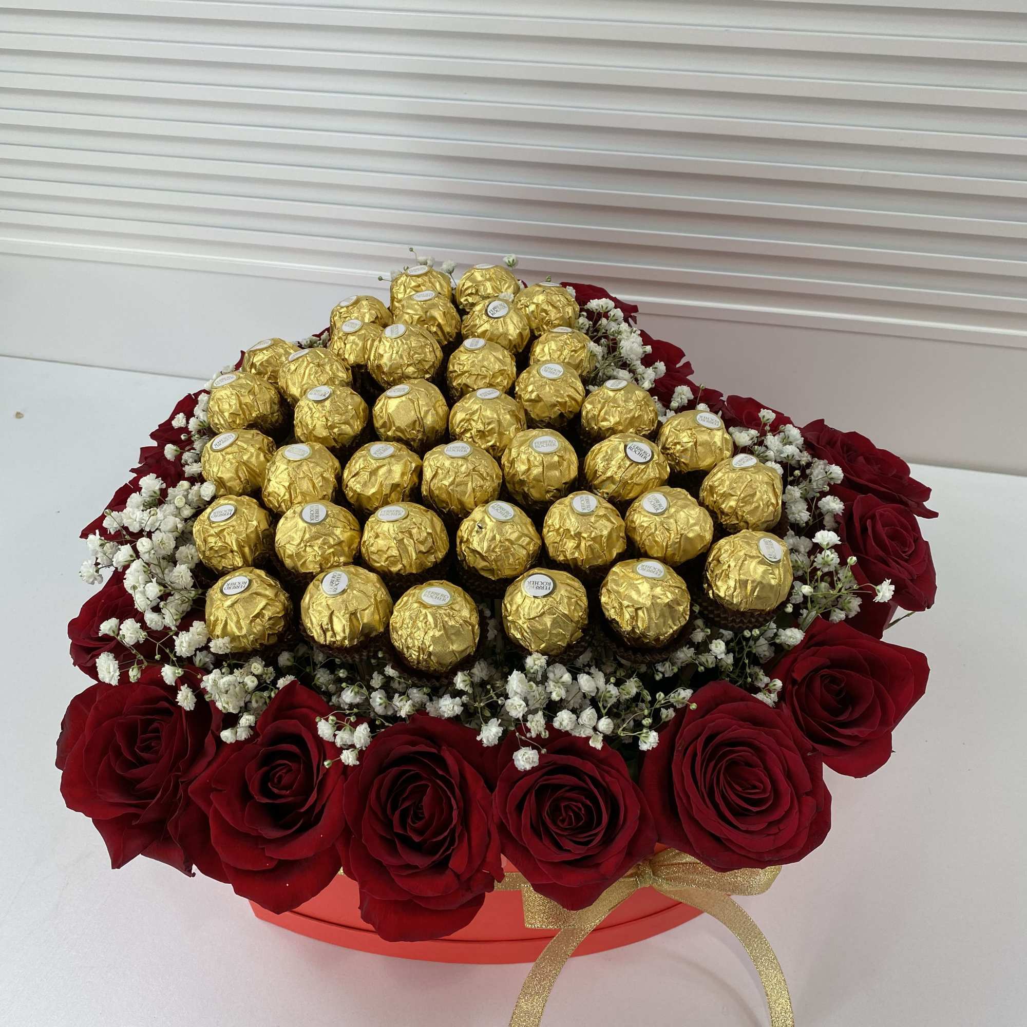 Red heart shape box filled with 20 roses and 32 Ferrero Rocher