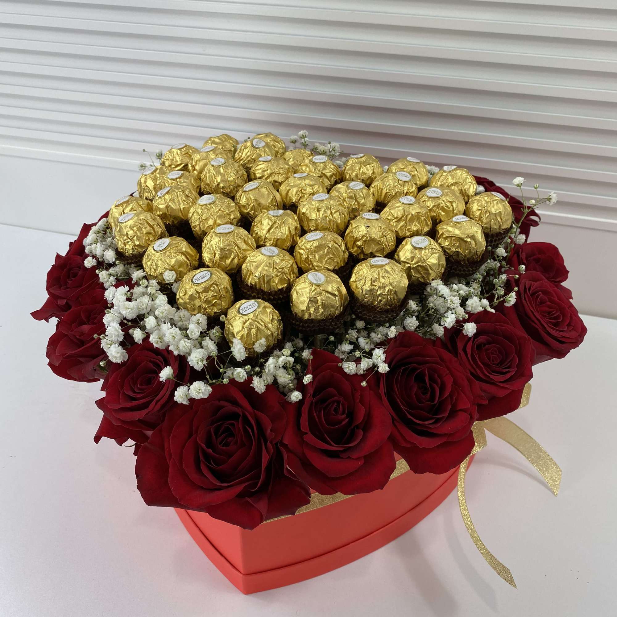 Red heart shape box filled with 20 roses and 32 Ferrero Rocher