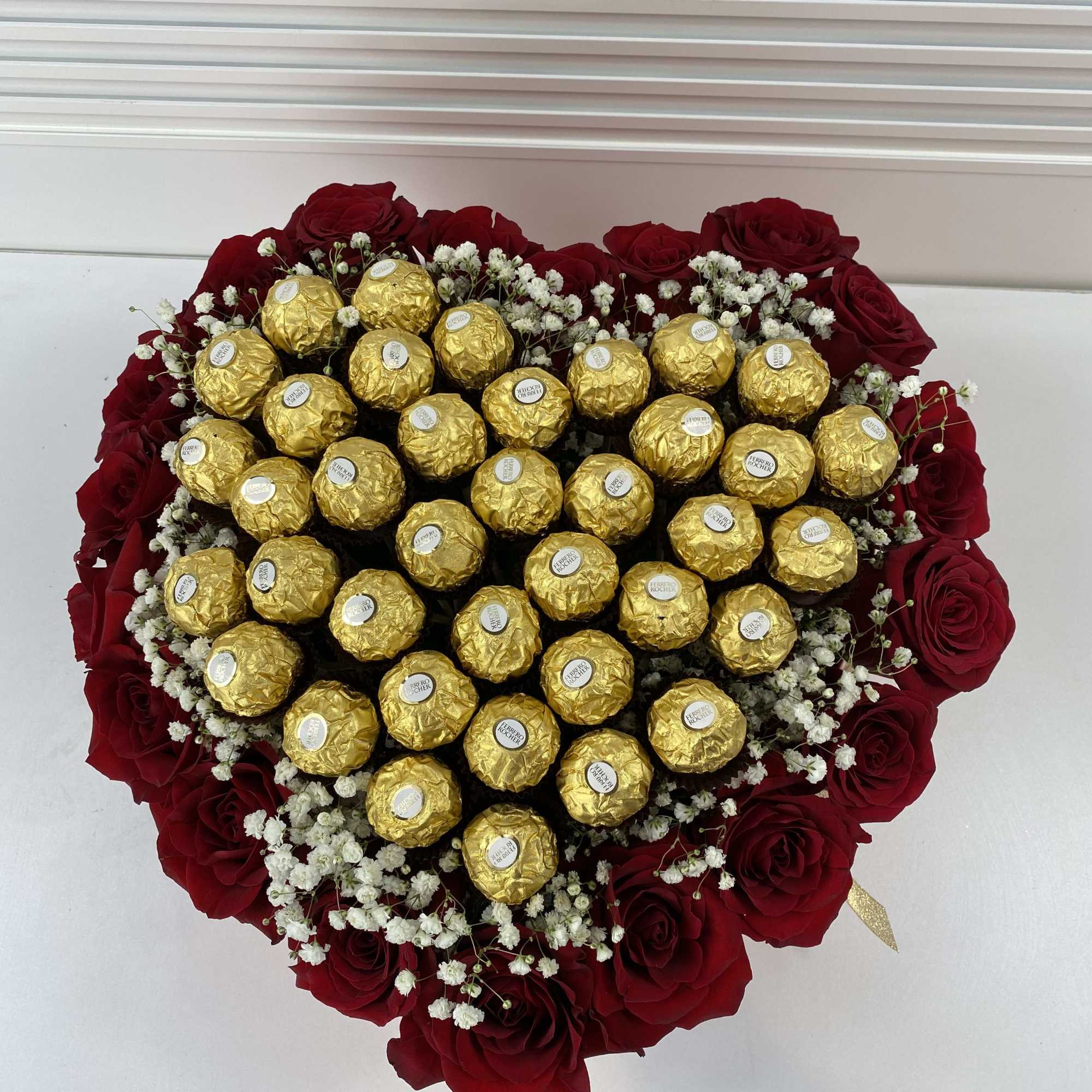 Red heart shape box filled with 20 roses and 32 Ferrero Rocher