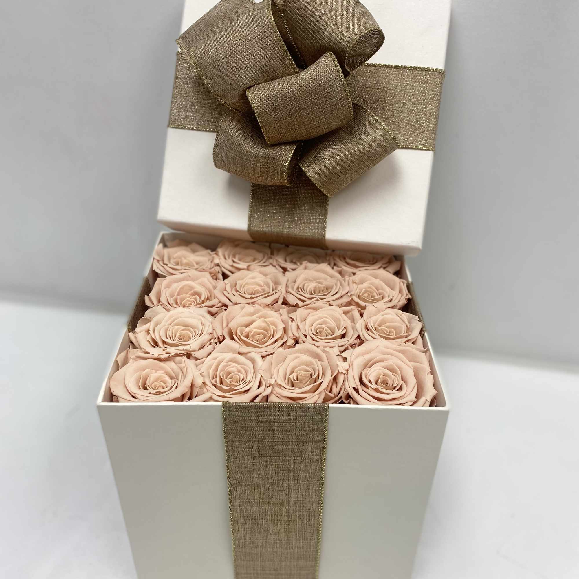 16 Champagne long lasting roses in a cream surprise box.