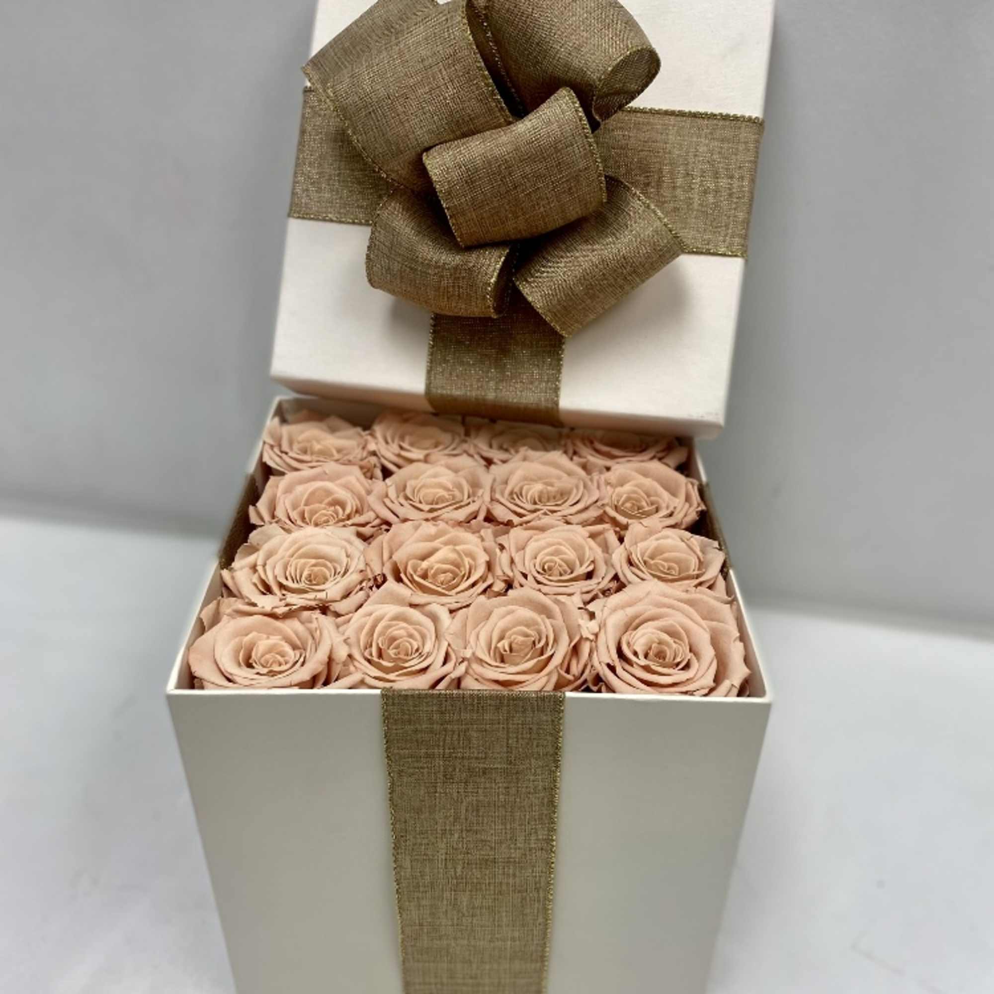 16 Champagne long lasting roses in a cream surprise box.