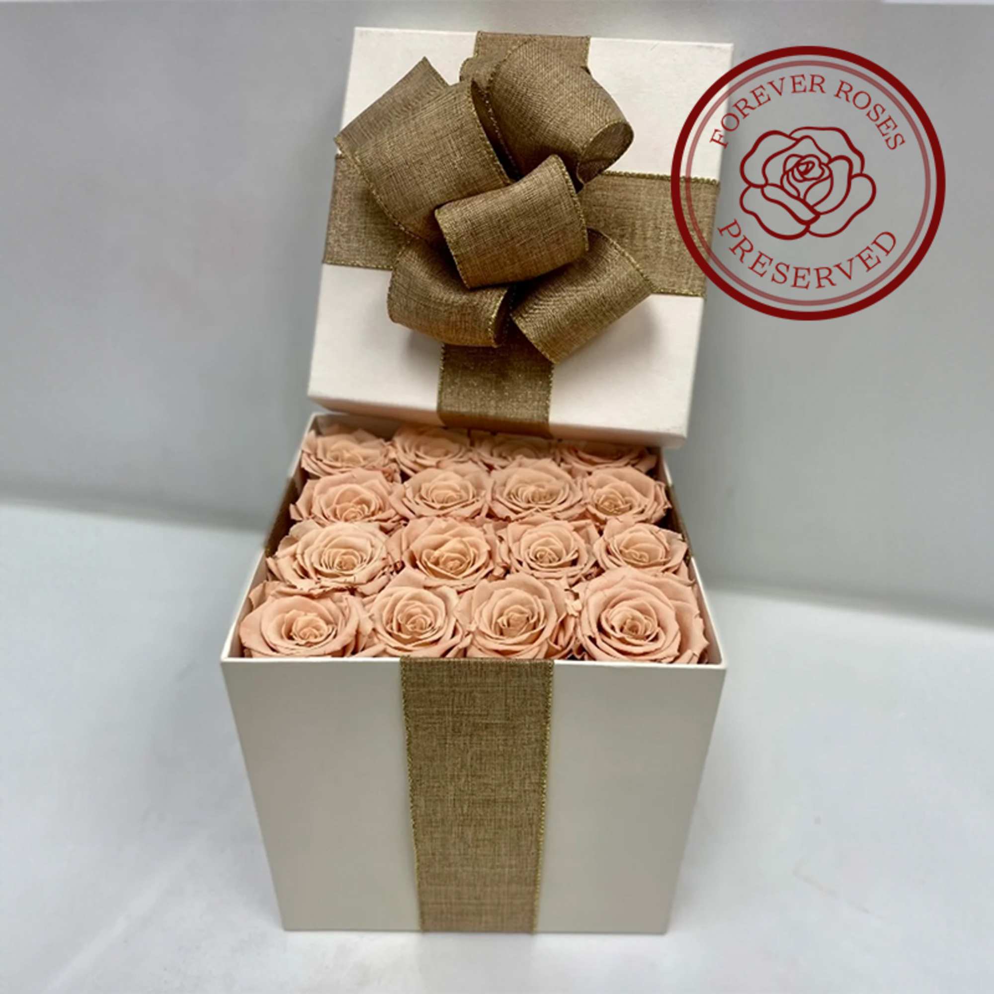 16 Champagne long lasting roses in a cream surprise box.