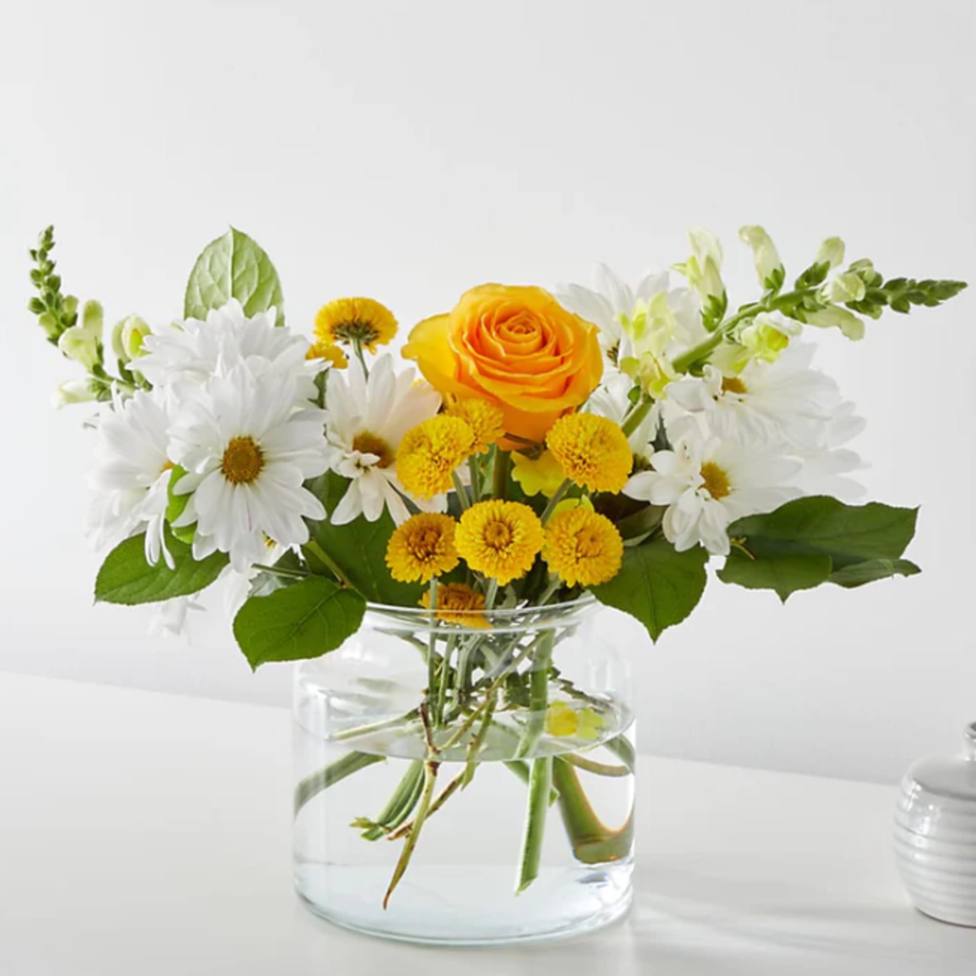Greet the morning with fresh yellow snapdragons, white daisies, and pink carnations