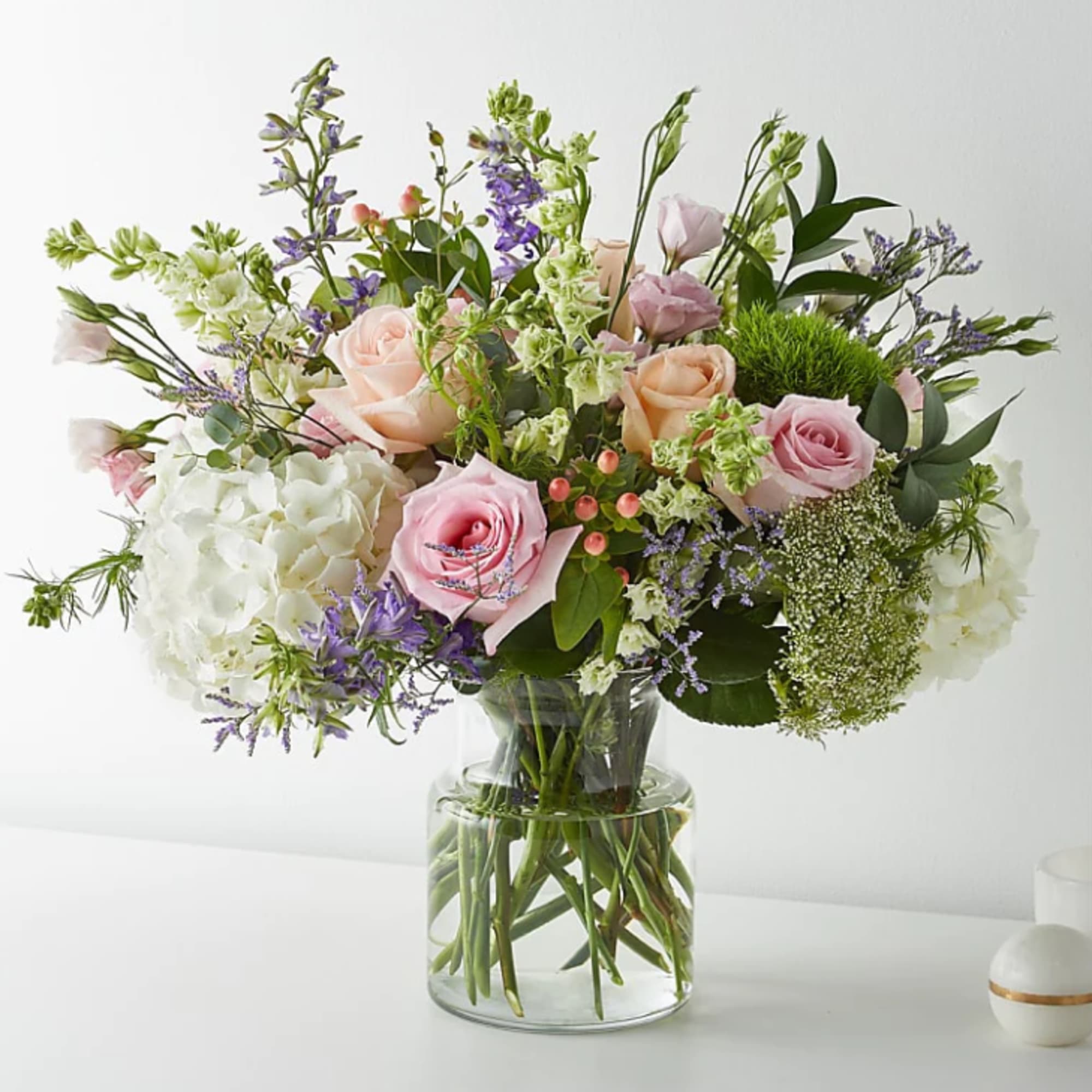 With its beautiful blend of roses, larkspurs, hypericum berries, Queen Anne's Lace With its beautiful blend of roses, larkspurs, hypericum berries, Queen Anne's Lace