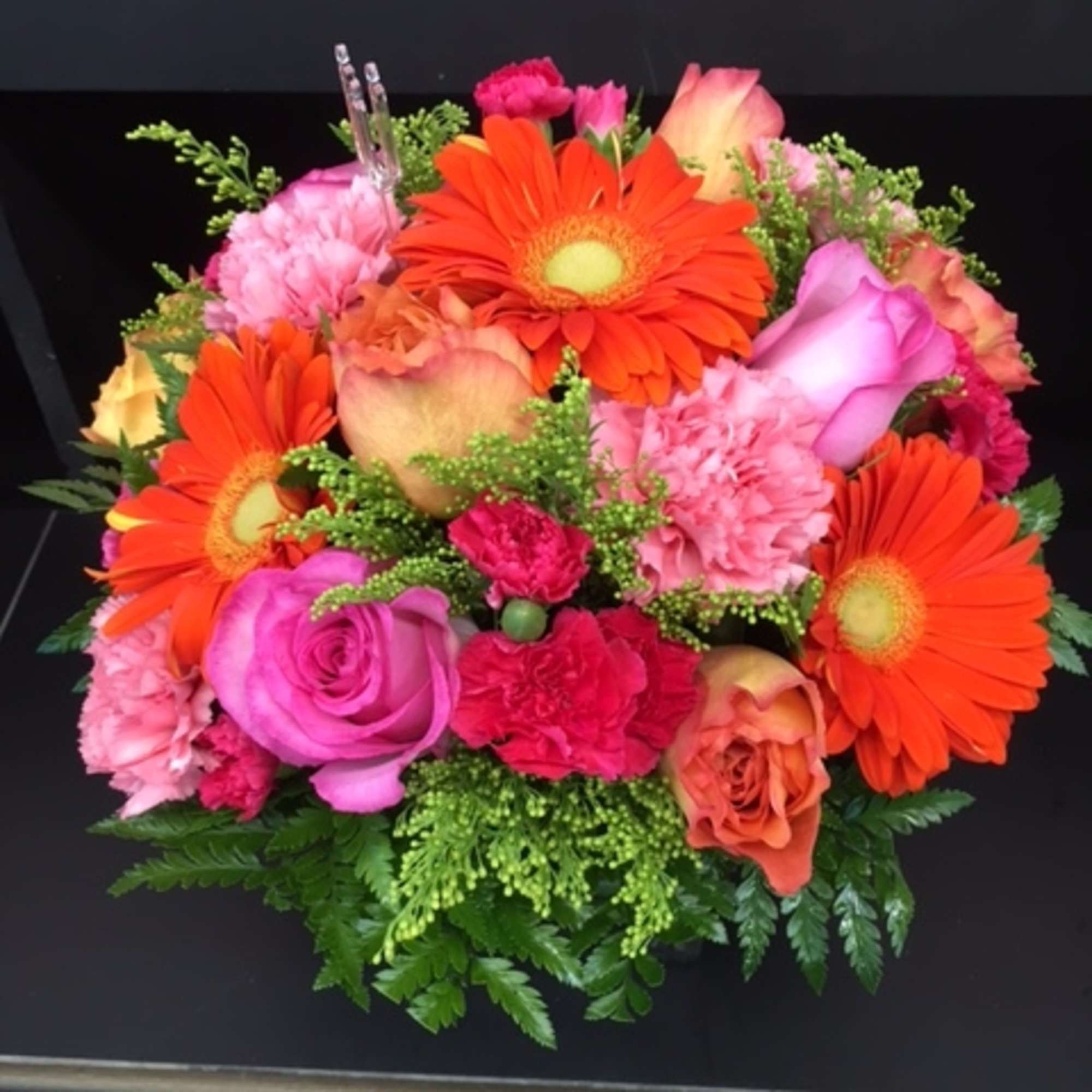 A mix of beautiful bright flowers hand-crafted and designed in a clear