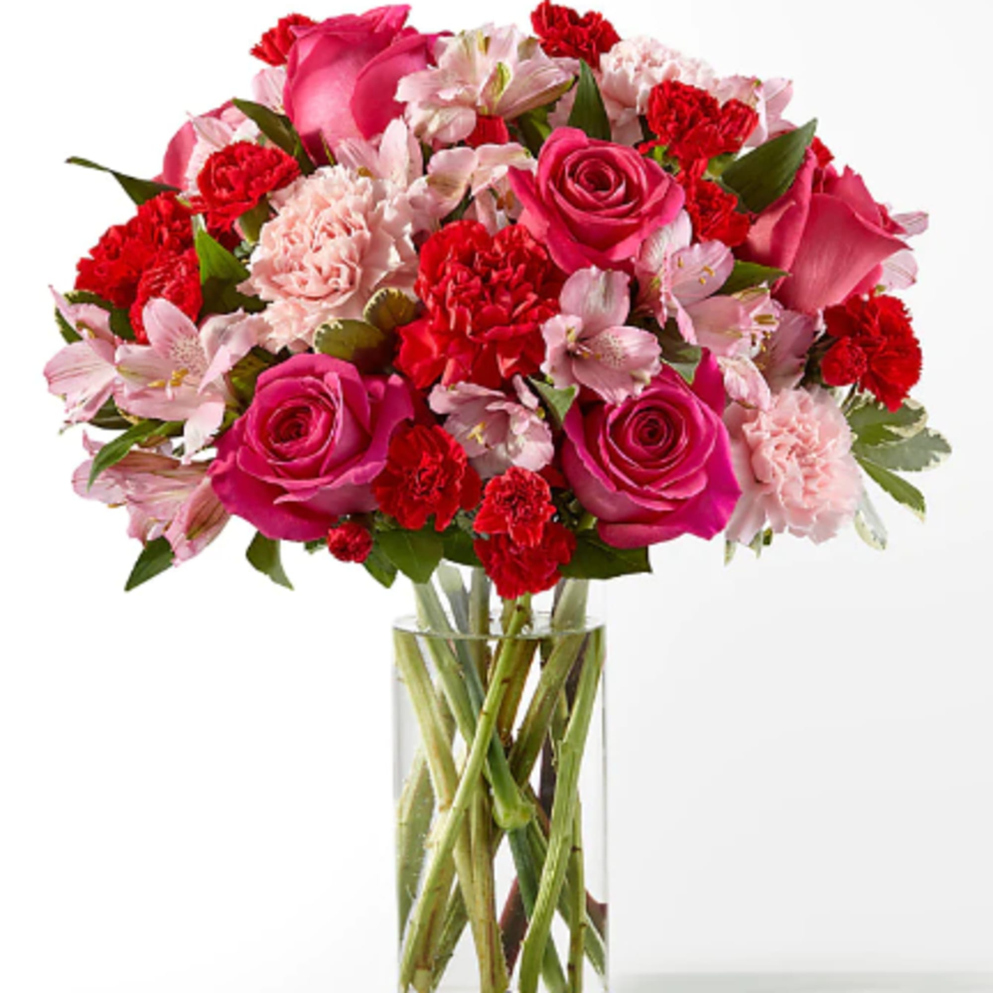 Blushing shades of pink blooms are nestled in lush greens to charm