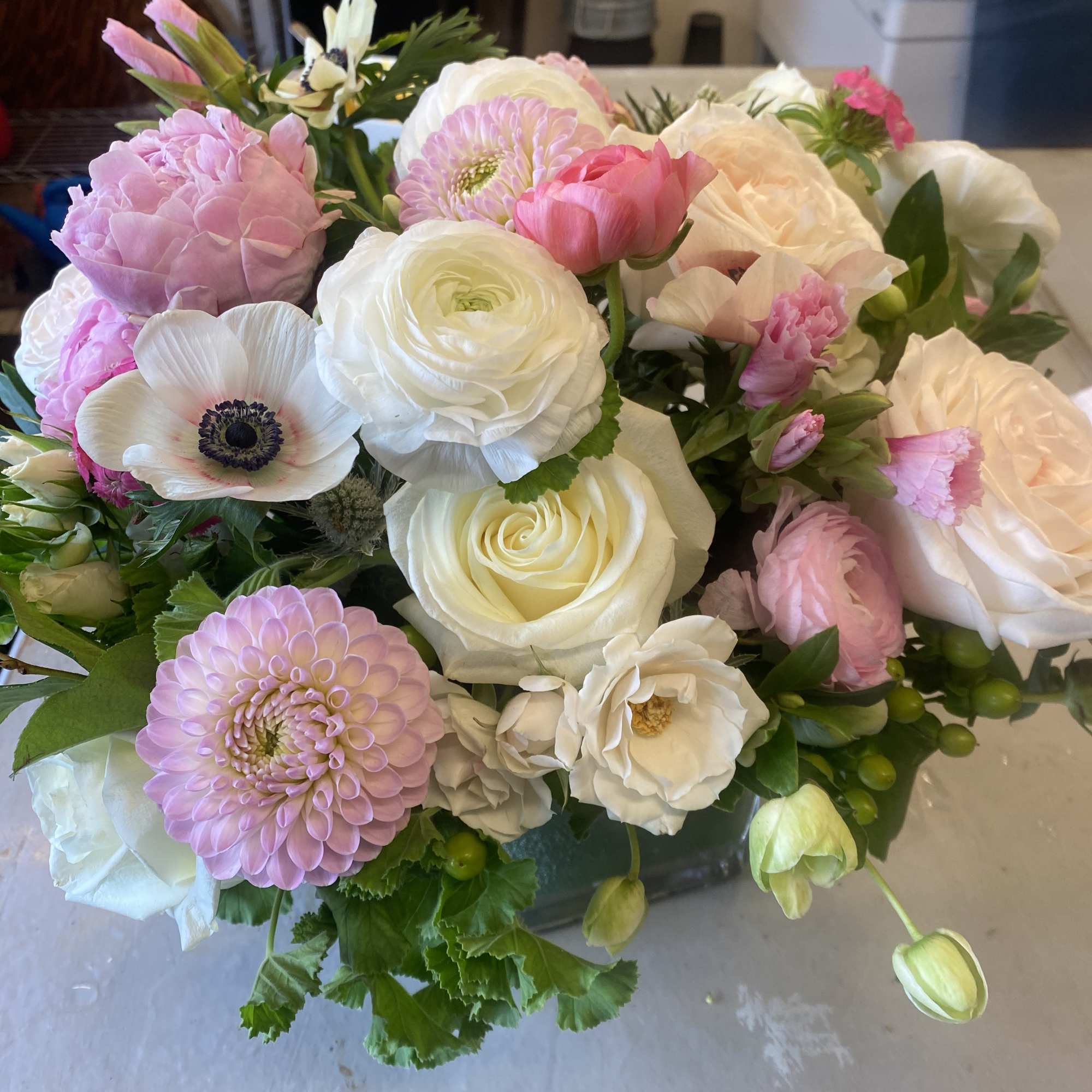 Pink &amp; pretty blooms in a clear glass vase with a ti