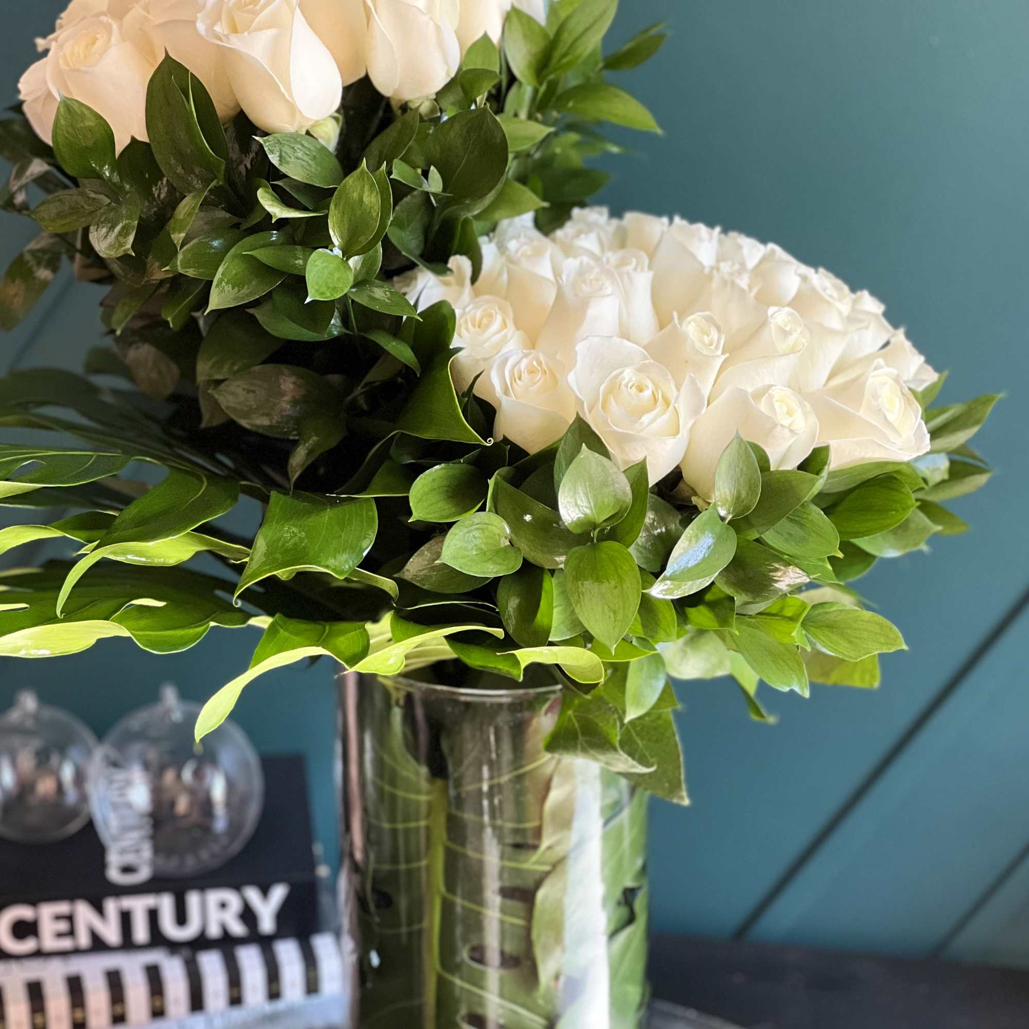 50 white roses design with greenery in a vase 