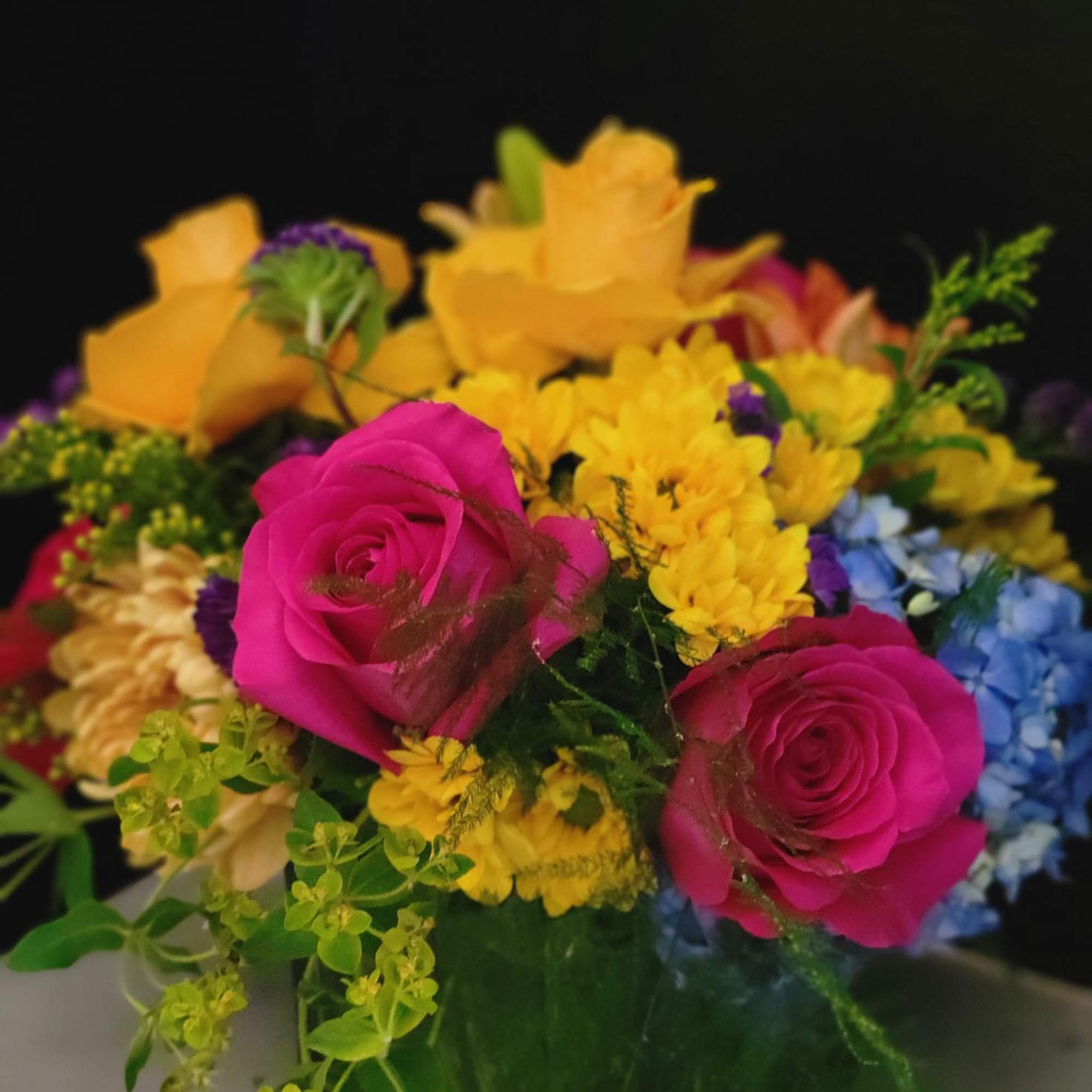 A vibrant color arrangement with hydrangeas, roses, stock, mums, and fillers