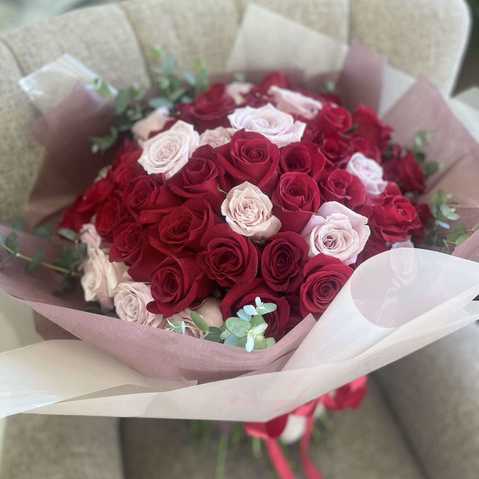 We create a custom designer choice Valentine or special occasion hand-tied bouquet.