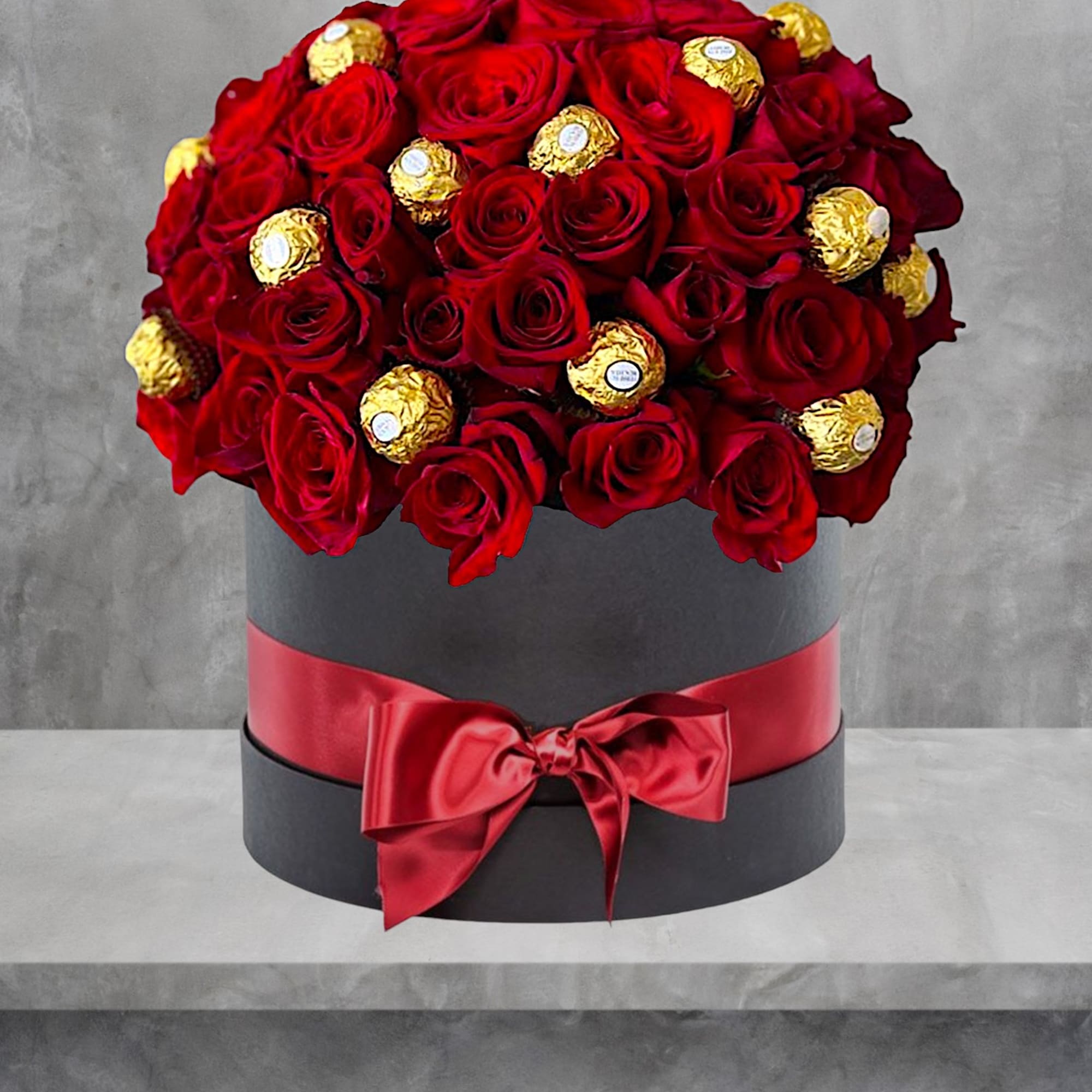 A modern flower arrangement in a cylinder box filled with roses &amp;