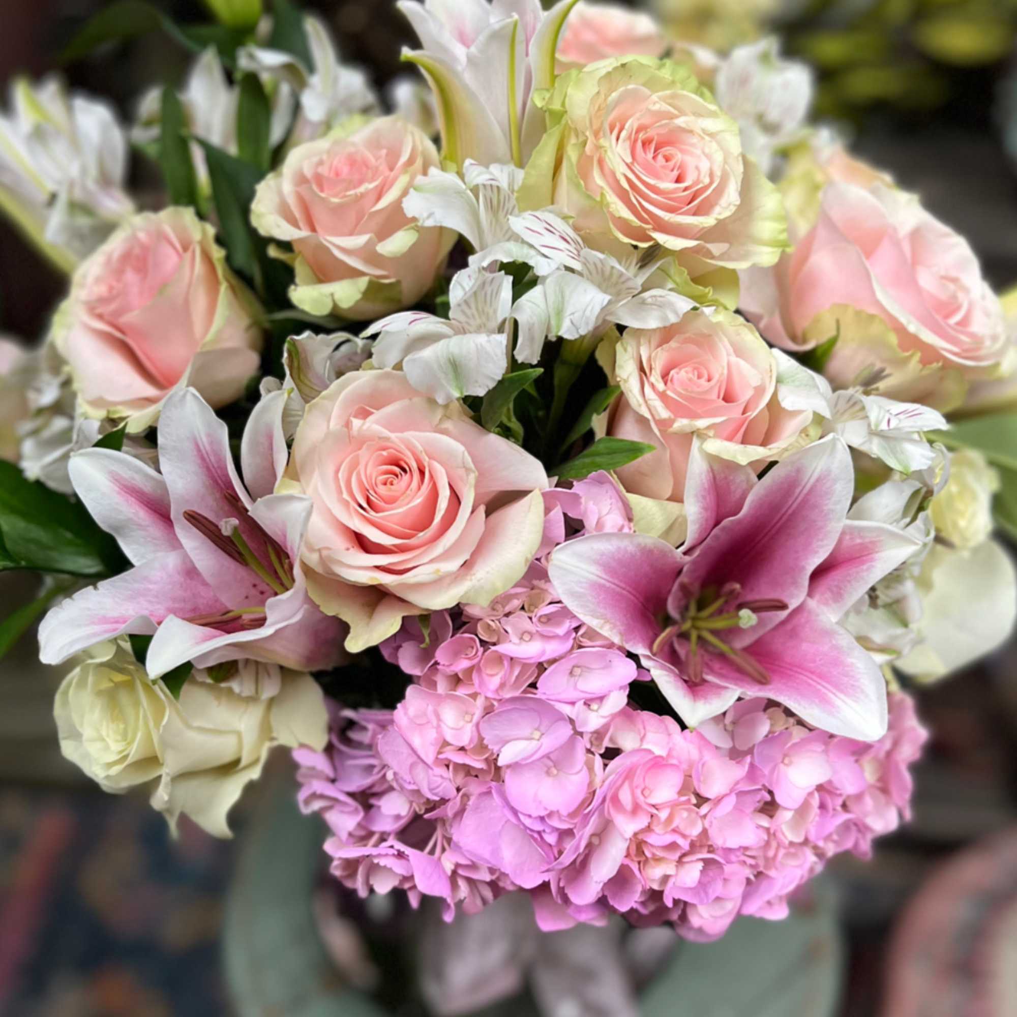 Soft tones of Pink Lillies with White Hydrangeas and Green arranged in