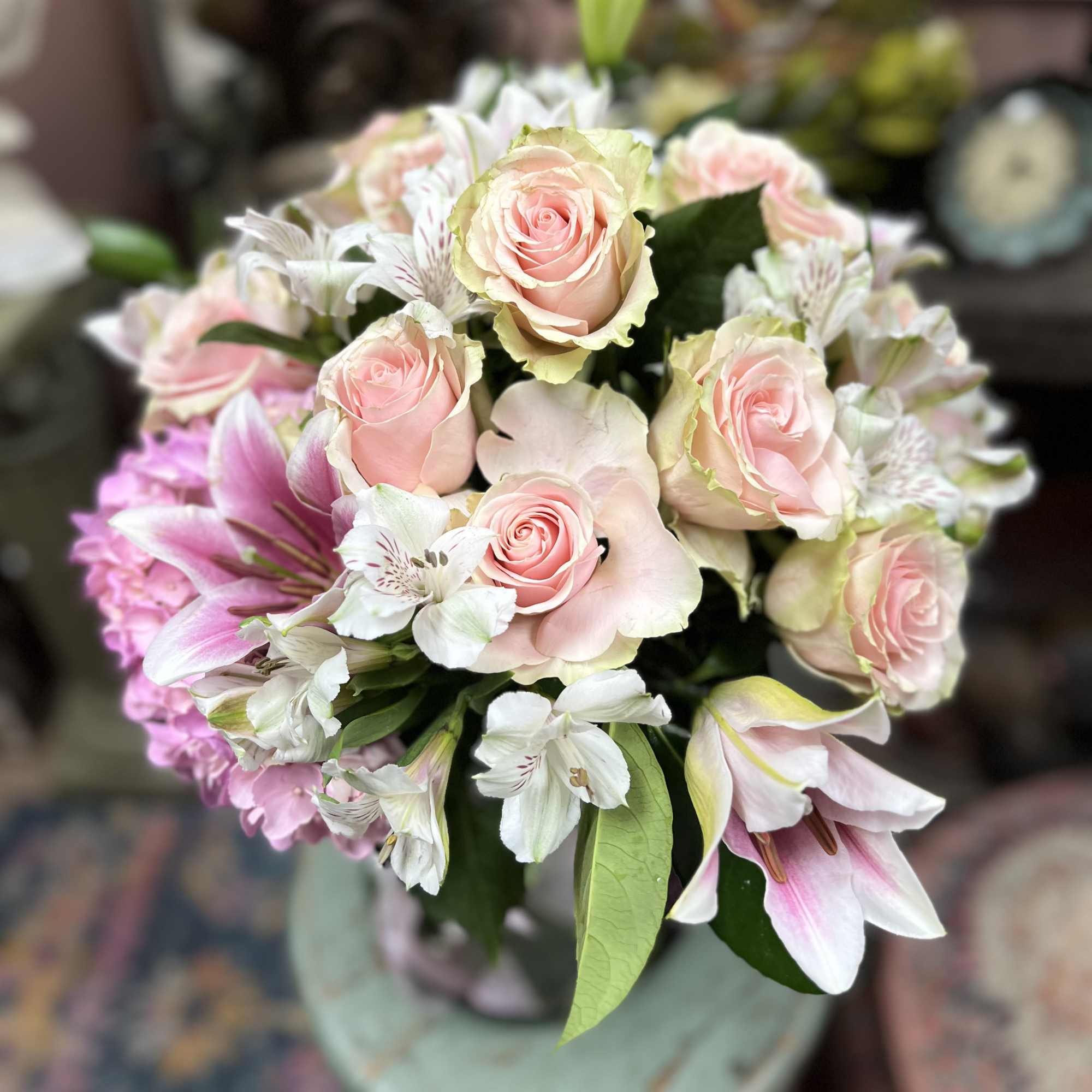 Soft tones of Pink Lillies with White Hydrangeas and Green arranged in
