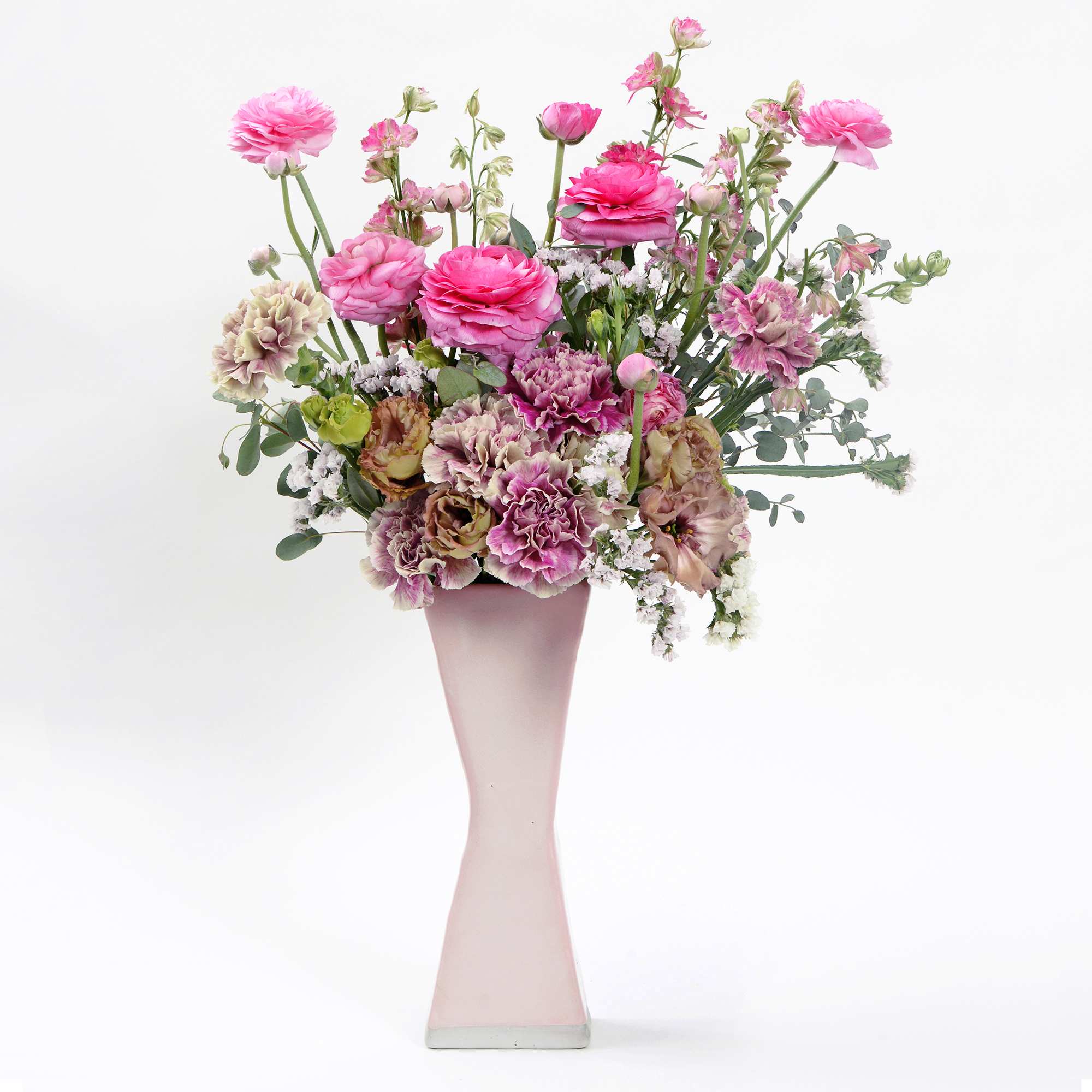 A handmade matte pink ceramic vase 10&quot; tall by 4&quot; wide filled