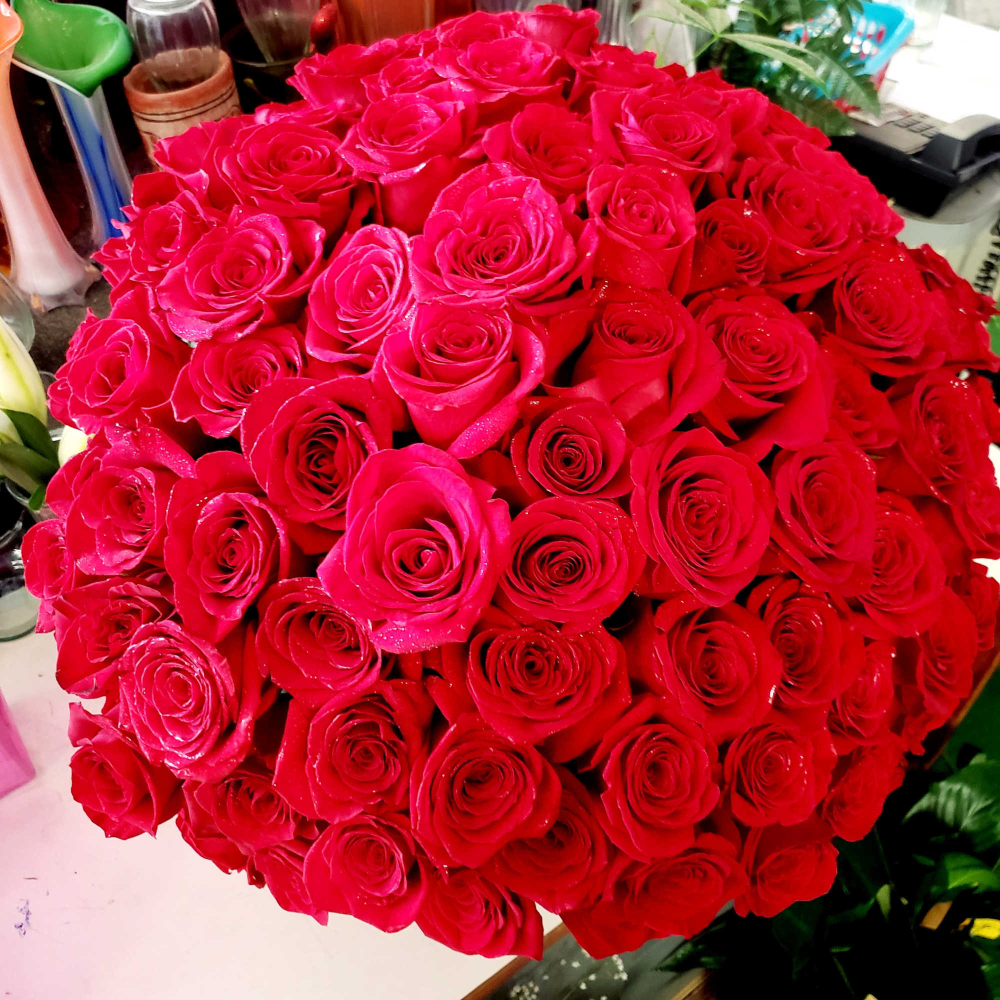 135 premium roses arranged in a black  container. Compact design.