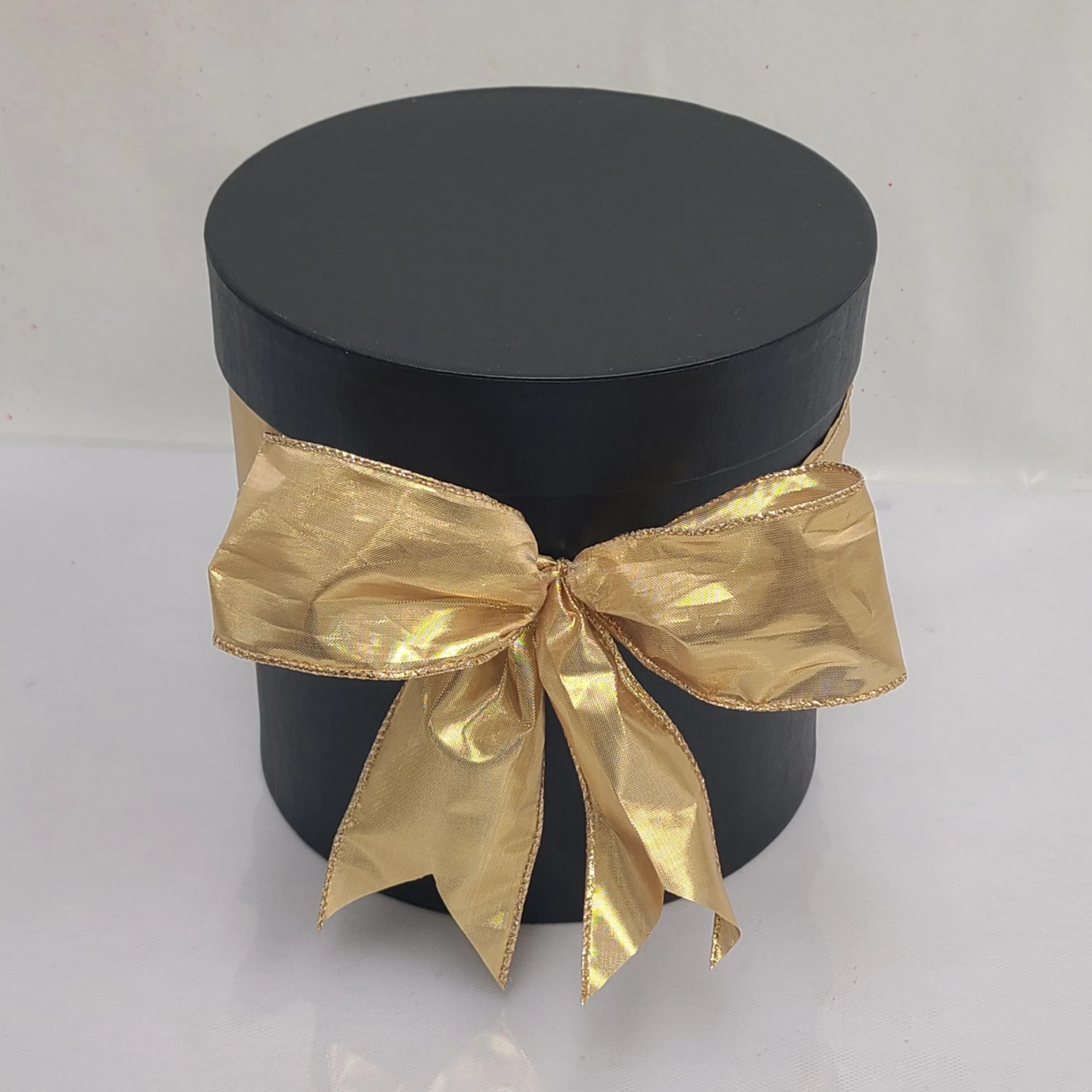 Round blank hat box with 12-14 red roses and baby breath. Surprise