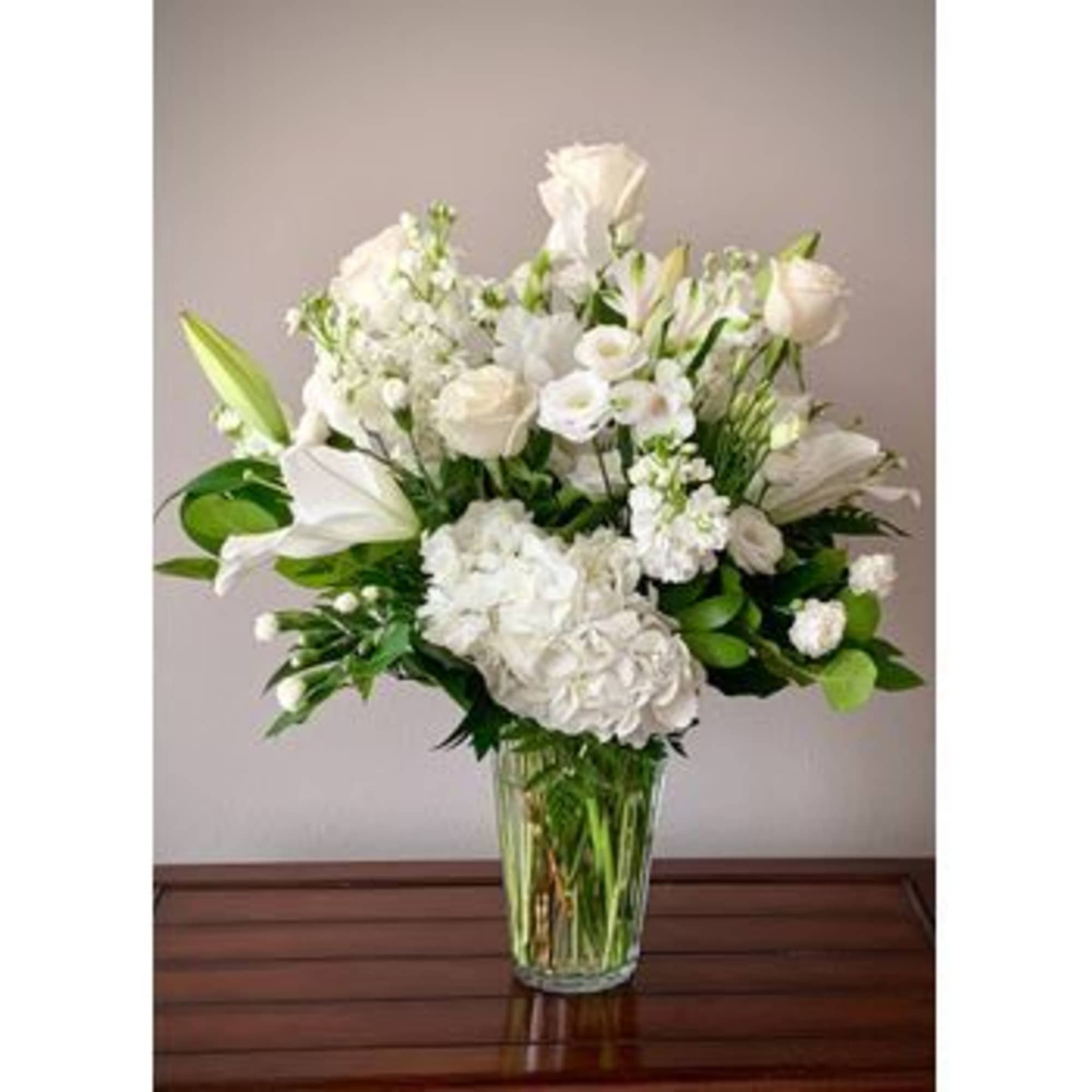 A classic mix of elegant white blooms, which may vary, according to