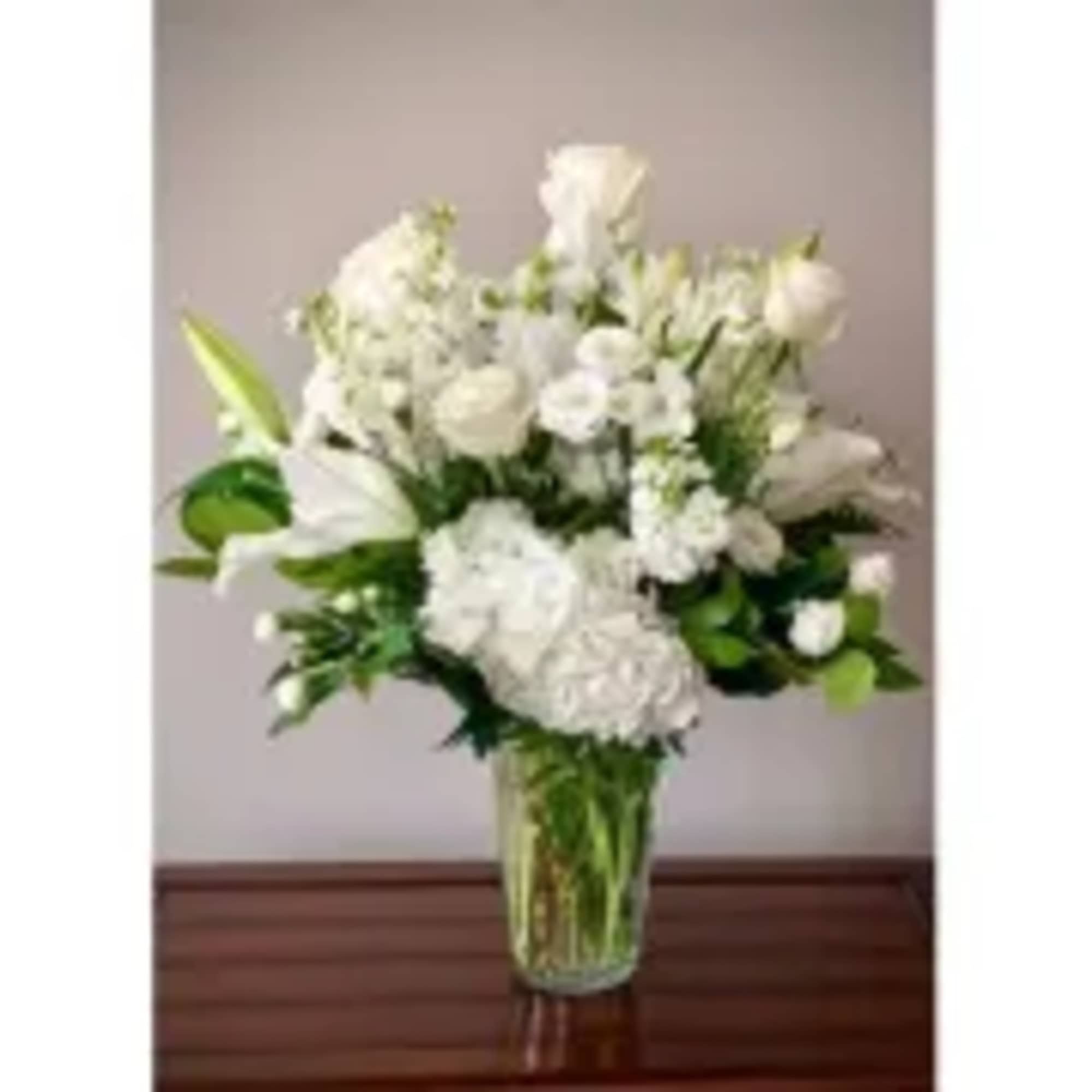 A classic mix of elegant white blooms, which may vary, according to