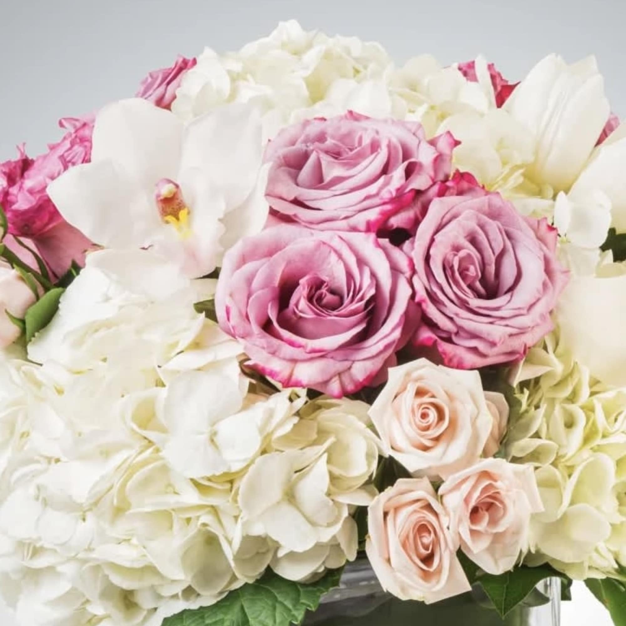 Classic and Beautiful, this large arrangement whispers luxury. Soft pinks, whites and