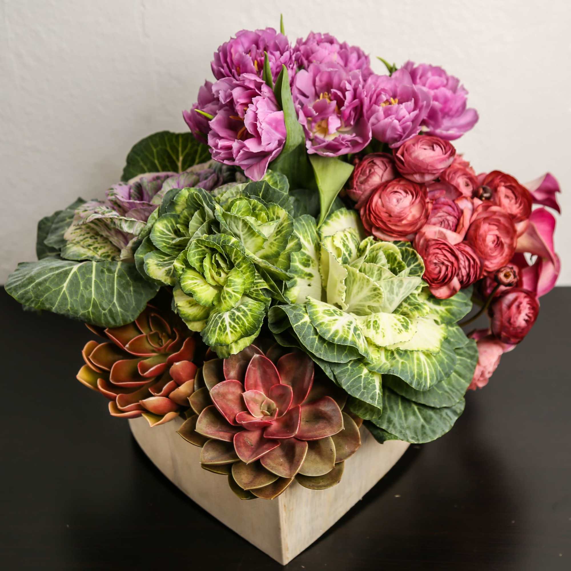 Composed of kale, tulips, ranunculus, Calla lily.
