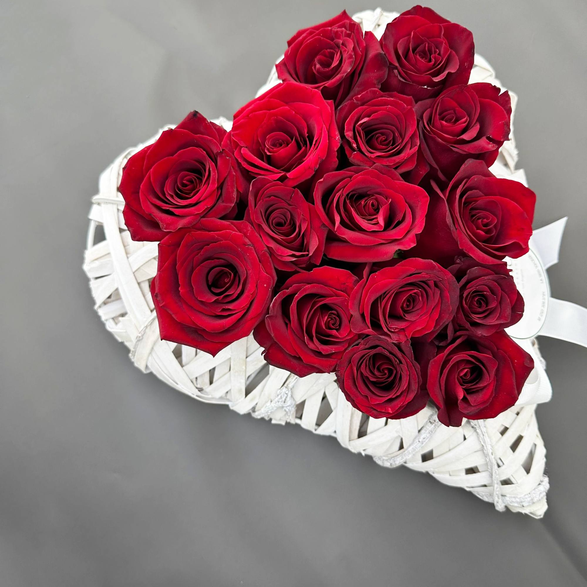 A total of 15 fresh red roses assembled in a romantic heart-shaped