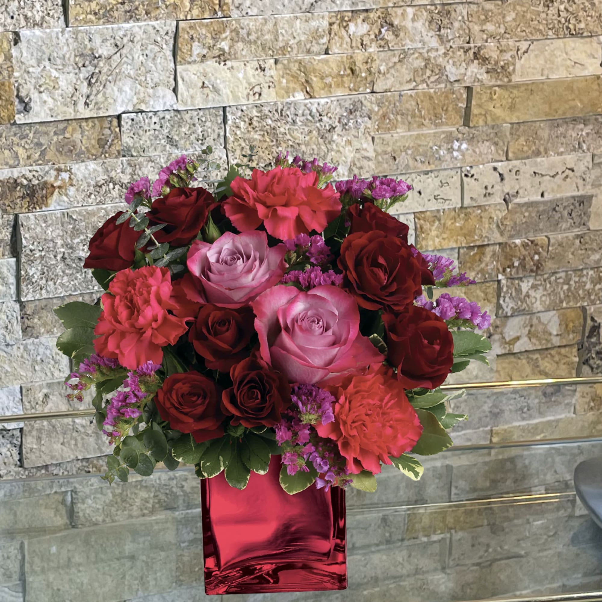Enrapture your paramour with this dramatic display of red and lavender roses.