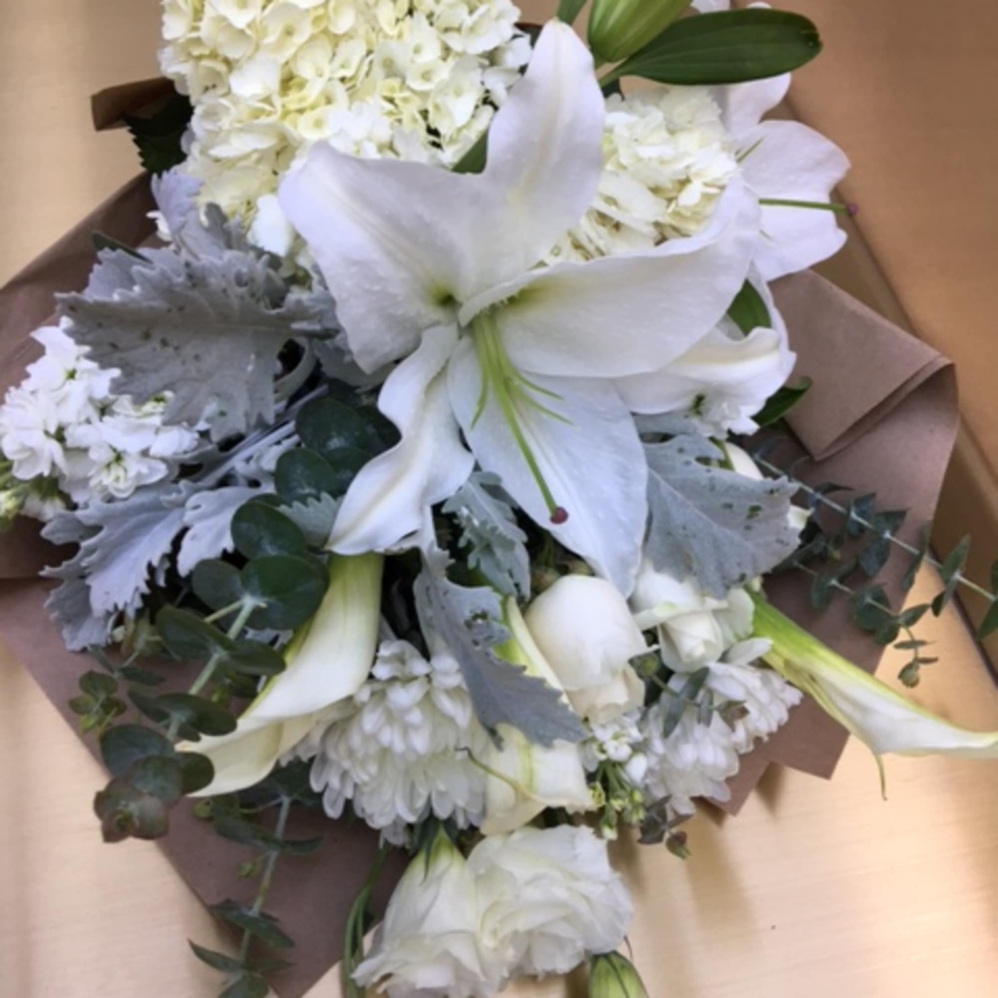 beautifully wrapped, this bouquet is composed of hydrangeas, roses, lilies,and stock. Its