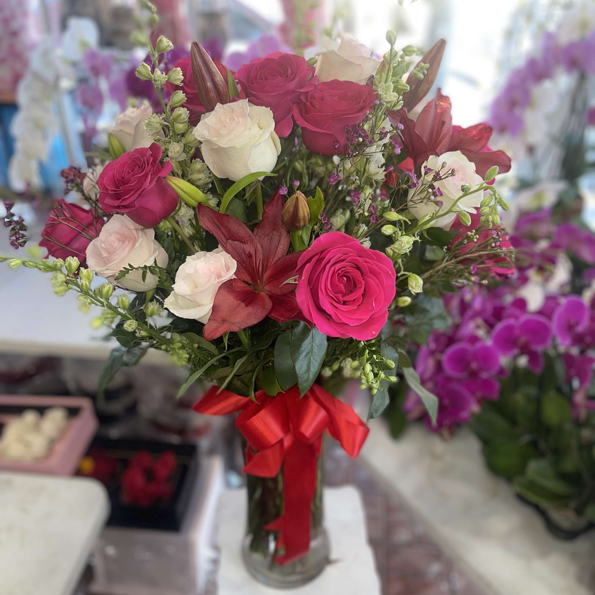 Lovely Tall Stemmed Mixed Flowers In a Beautiful Vase