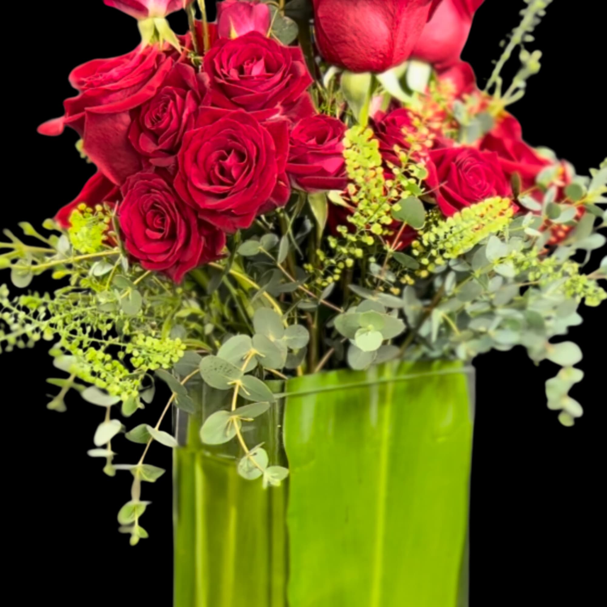 A vertical Red Roses flower arrangement designed in a clear glass vase