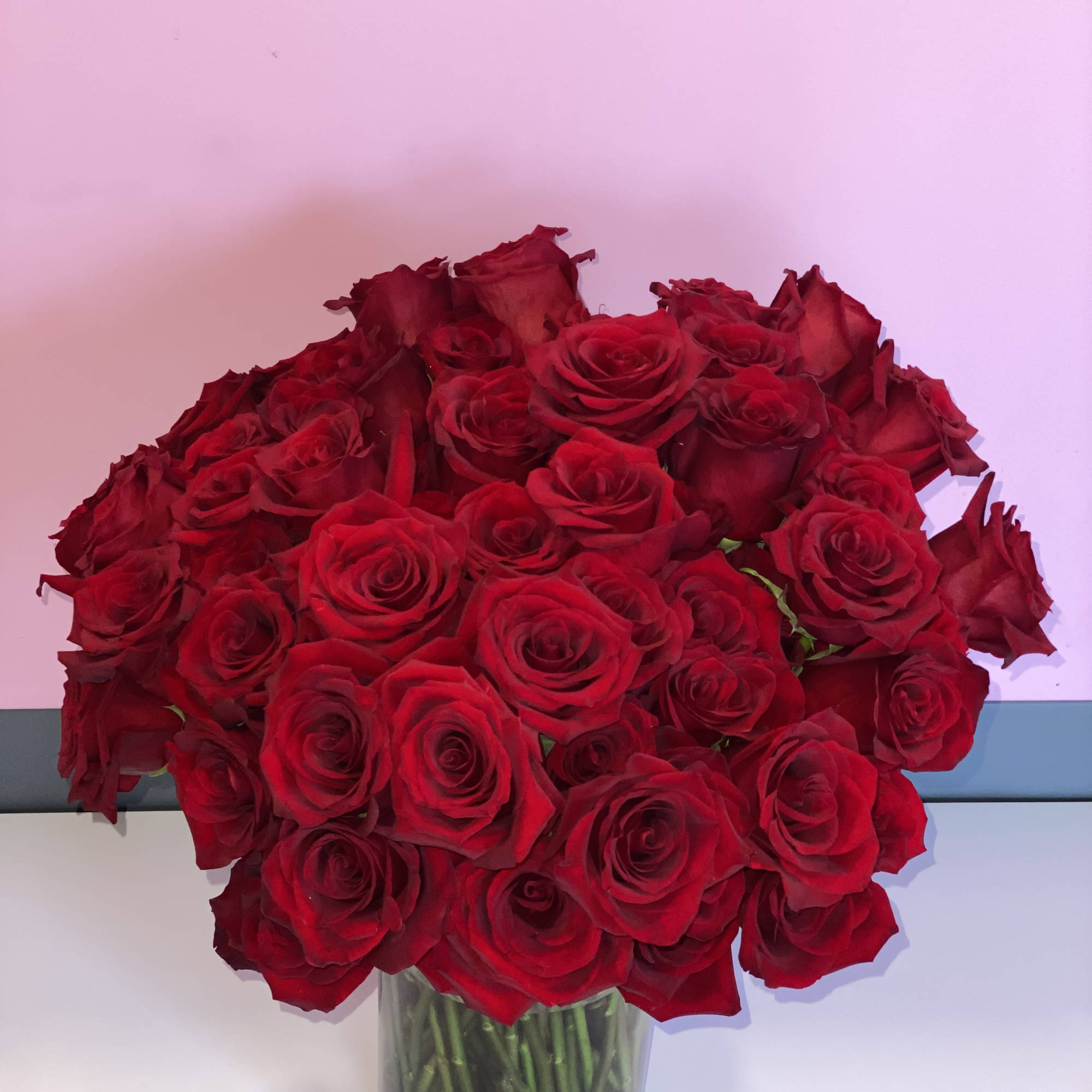 This stunning vase arrangement is comprised of 100 lush red roses. This