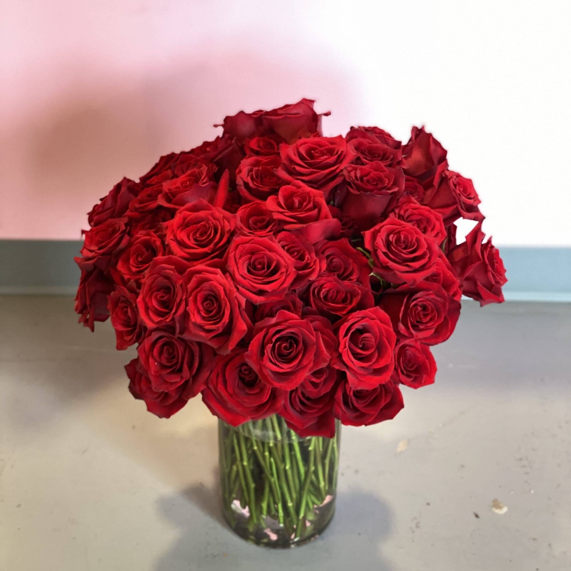 This stunning vase arrangement is comprised of 100 lush red roses. This