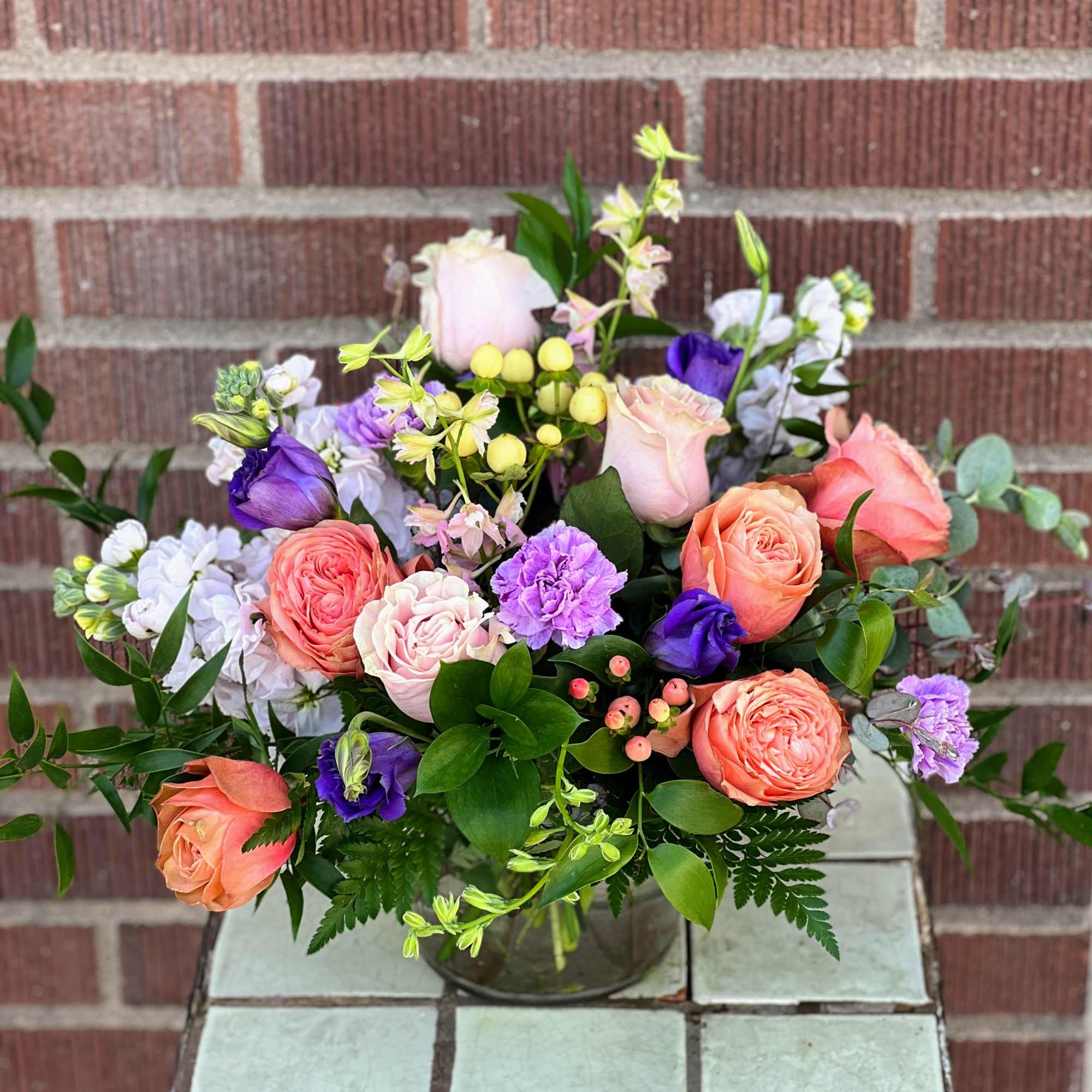 Designed by one of our local girls, this soft arrangement in peaches Designed by one of our local girls, this soft arrangement in peaches