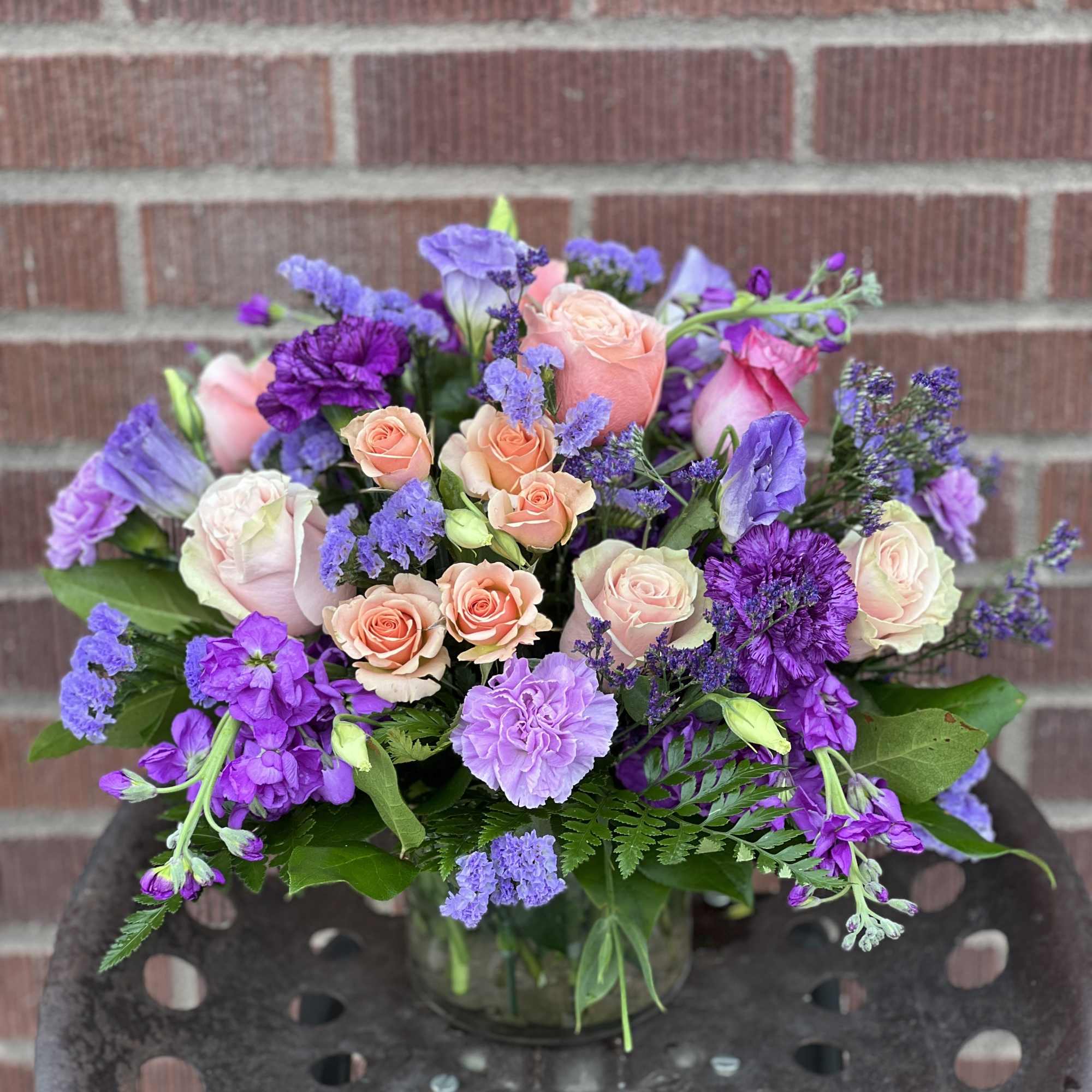 Designed by one of our local girls, this soft arrangement in peaches Designed by one of our local girls, this soft arrangement in peaches