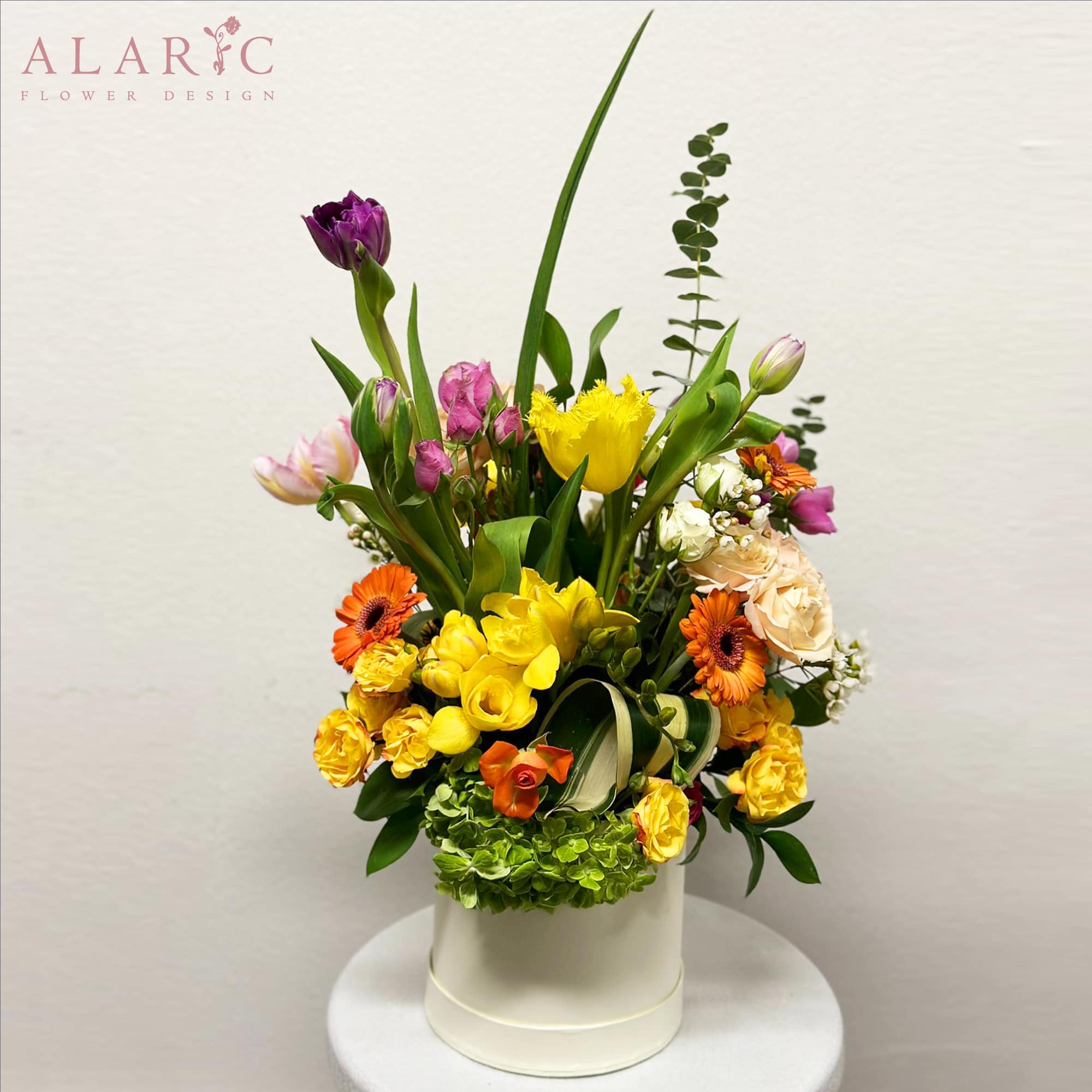 A vibrant mix of tulips, hydrangeas, roses and gerbera daisies and some