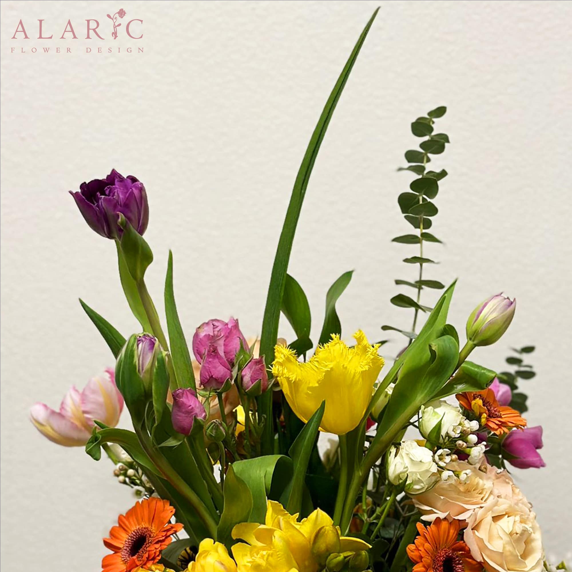 A vibrant mix of tulips, hydrangeas, roses and gerbera daisies and some