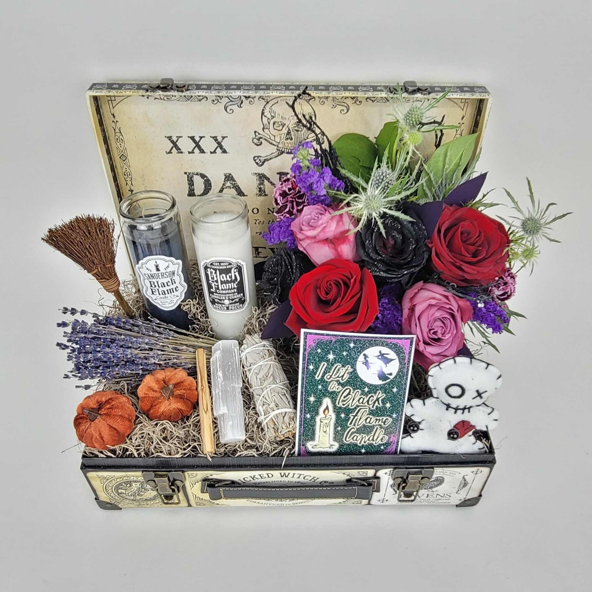 A beautiful box with a small arrangement, candles, and a small sage A beautiful box with a small arrangement, candles, and a small sage